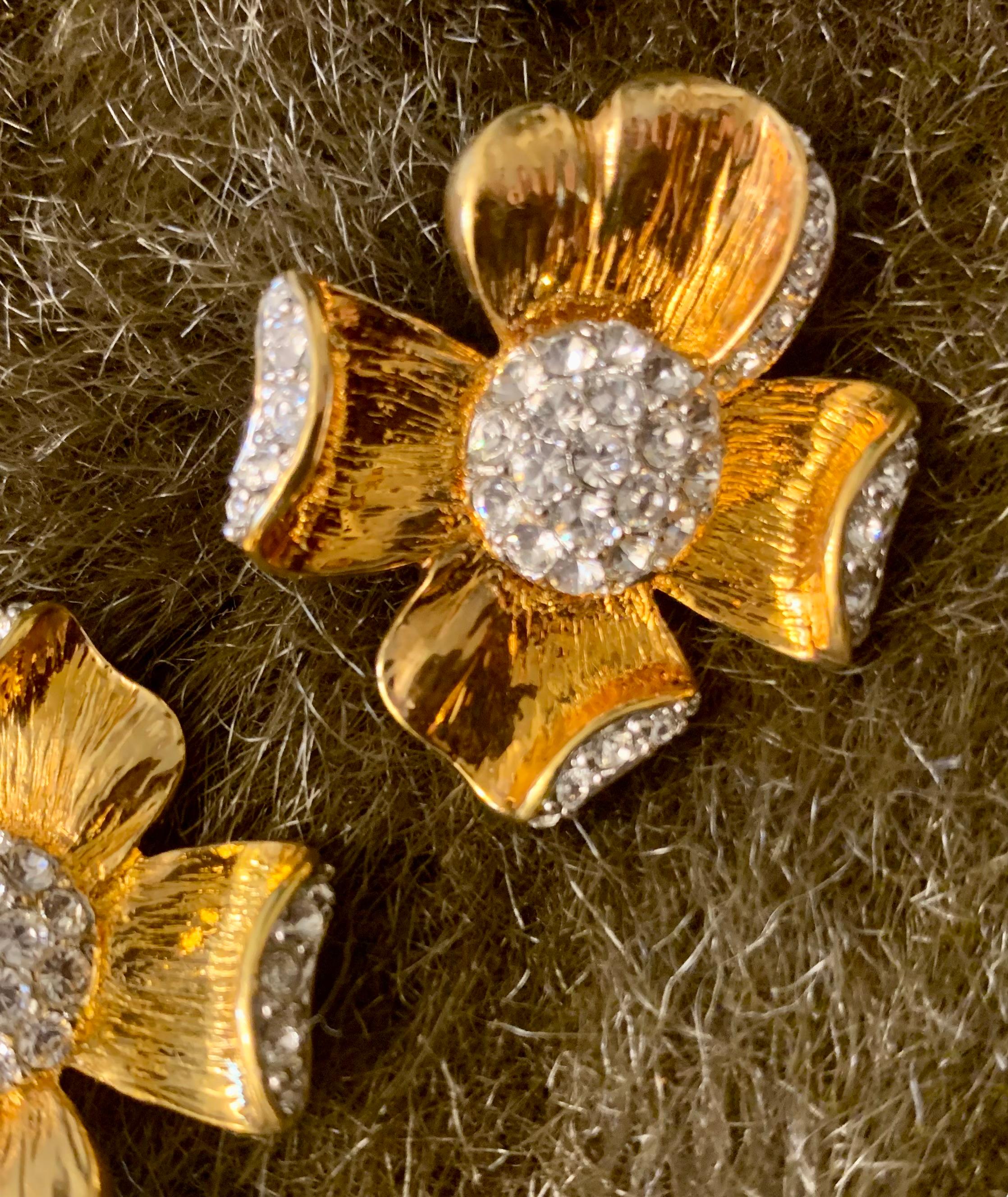 From the Dynasty TV show era, a NIB pair of chic Flowe Blossum clip earrings. Textured gold plate with beautiful rhinestone centers. This collection included a faux pearl bracelet with larger flower accent. (Ours available on separate listing).