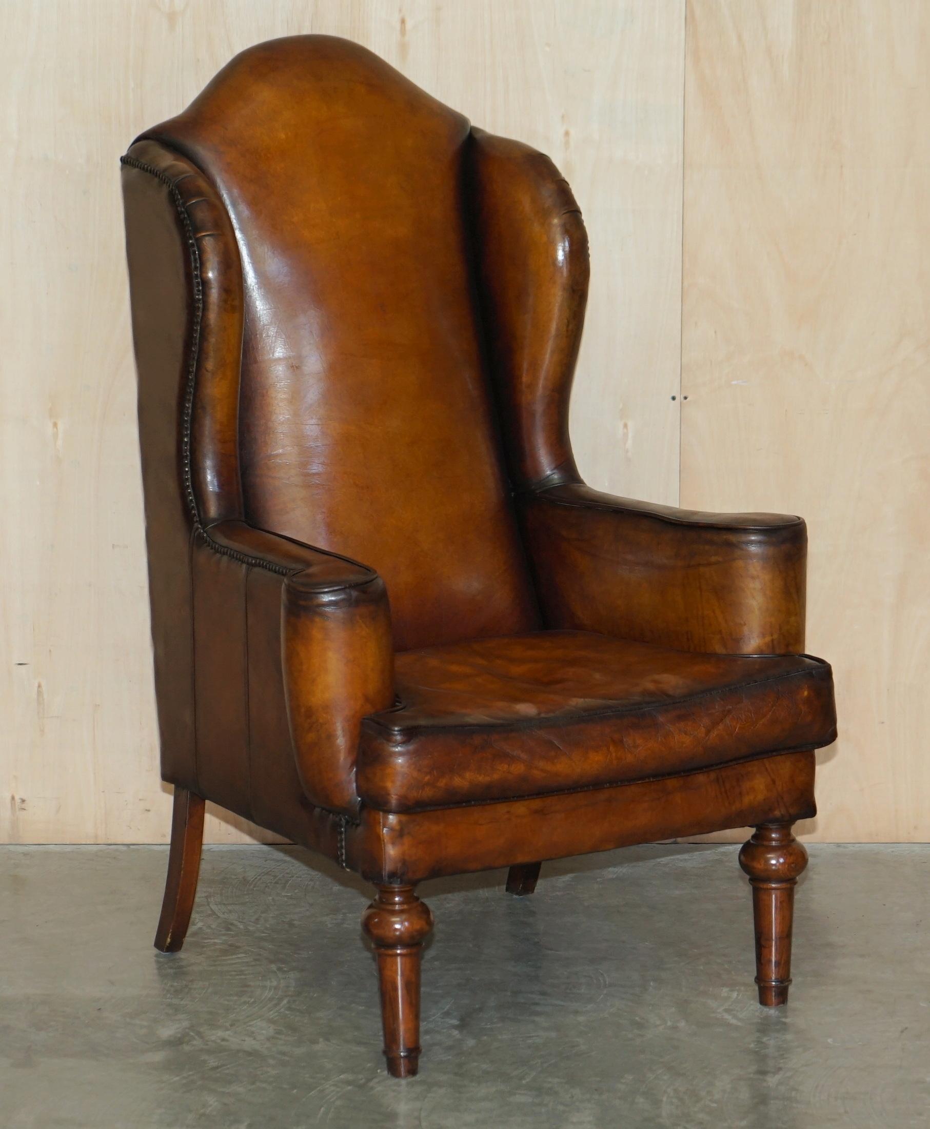 We are delighted to offer for sale this very rare pair of large, fully restored vintage William Morris style hand dyed cigar brown leather wingback armchairs with oak frames

These chairs are very fine examples, they have elegant long oak turned