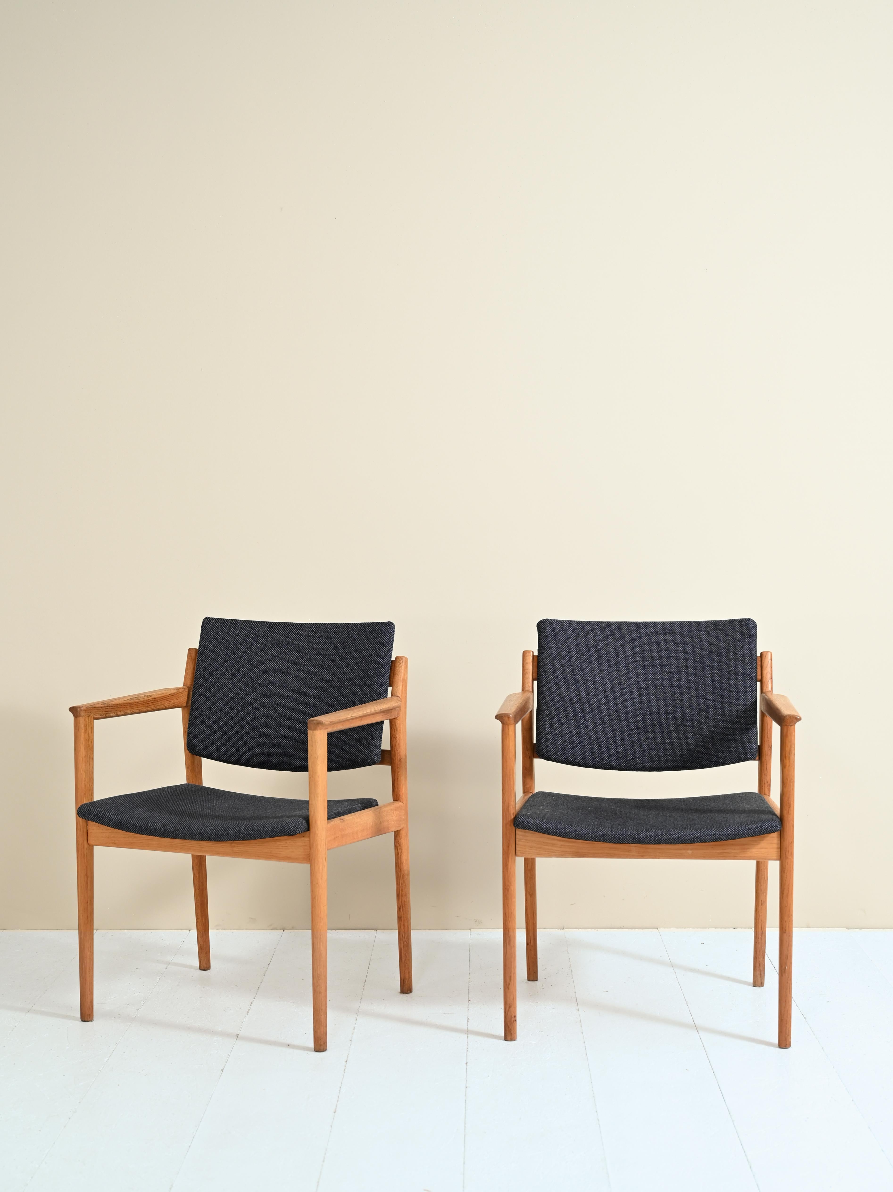 Pair of armchairs with armrests made in Sweden in the 1960s by Karl Erik Ekselius for J.O. Carlsson.

The armchairs features the simple and elegant Scandinavian mid-century forms; the frame is made of oak wood.

The back and seat are covered by