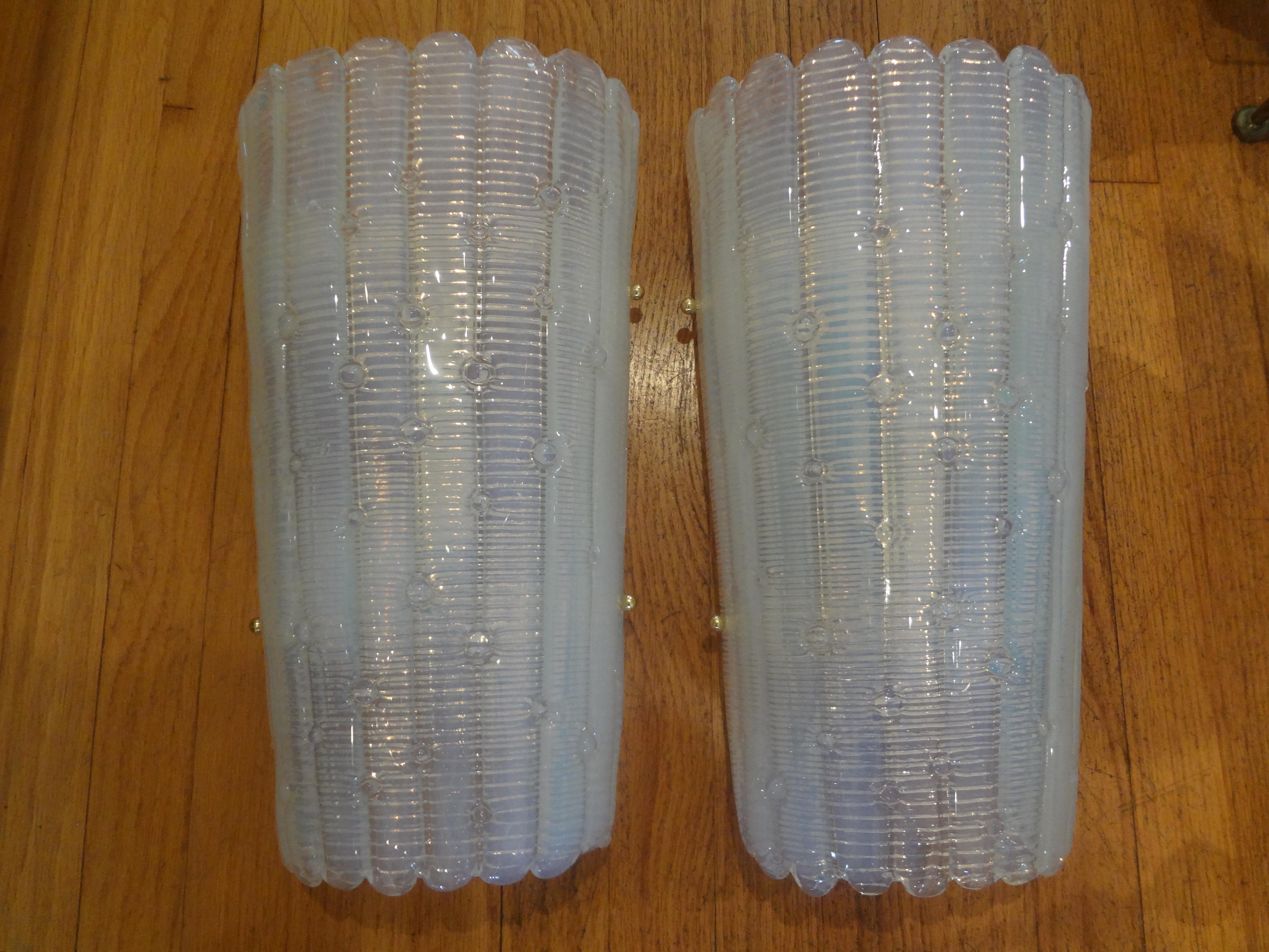 Stunning pair of vintage opalescent murano glass sconces. This large pair of Barovier style murano glass sconces have a beautiful ribbed effect with raised points. These gorgeous modernist murano glass sconces each have two Edison sockets and have