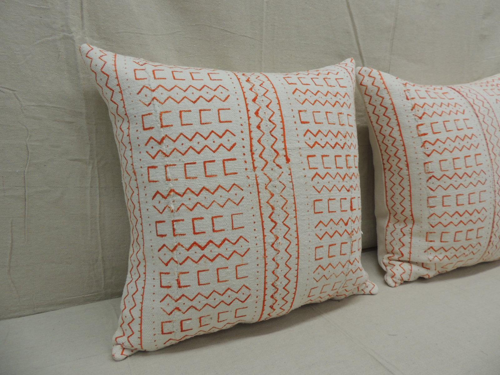 Pair of vintage orange and natural African mud cloth square decorative pillows
with textured white heavy linen backings.
Decorative pillow handcrafted and designed in the USA. 
Closure by stitch (no zipper closure) with custom made pillow