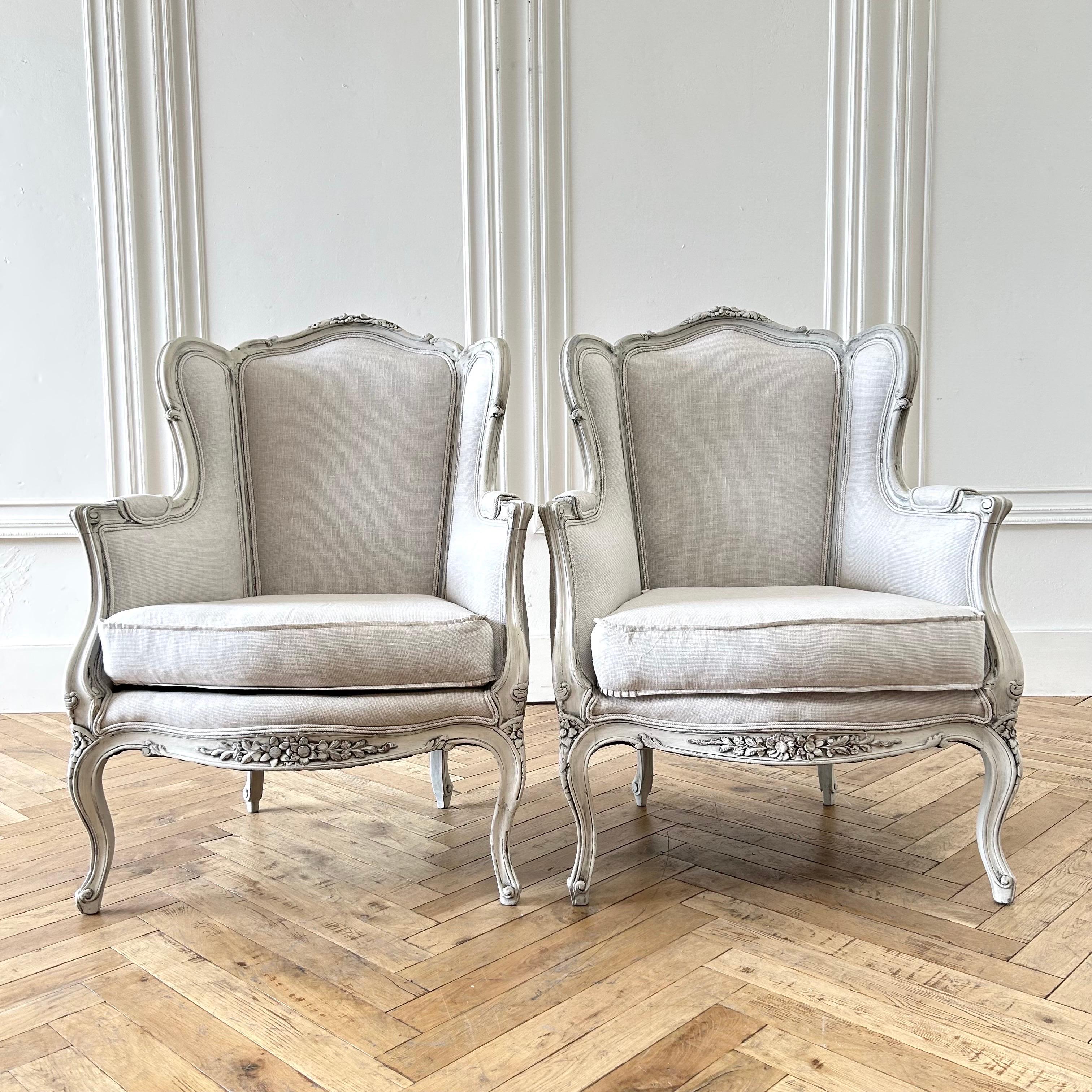 Pair of vintage painted and upholstered linen bergere chairs.
A soft distressed oyster white finish with an aged patina, upholstered in natural linen with a small gingham check. The seats have a pleated ruffle corner.
Solid and sturdy ready for