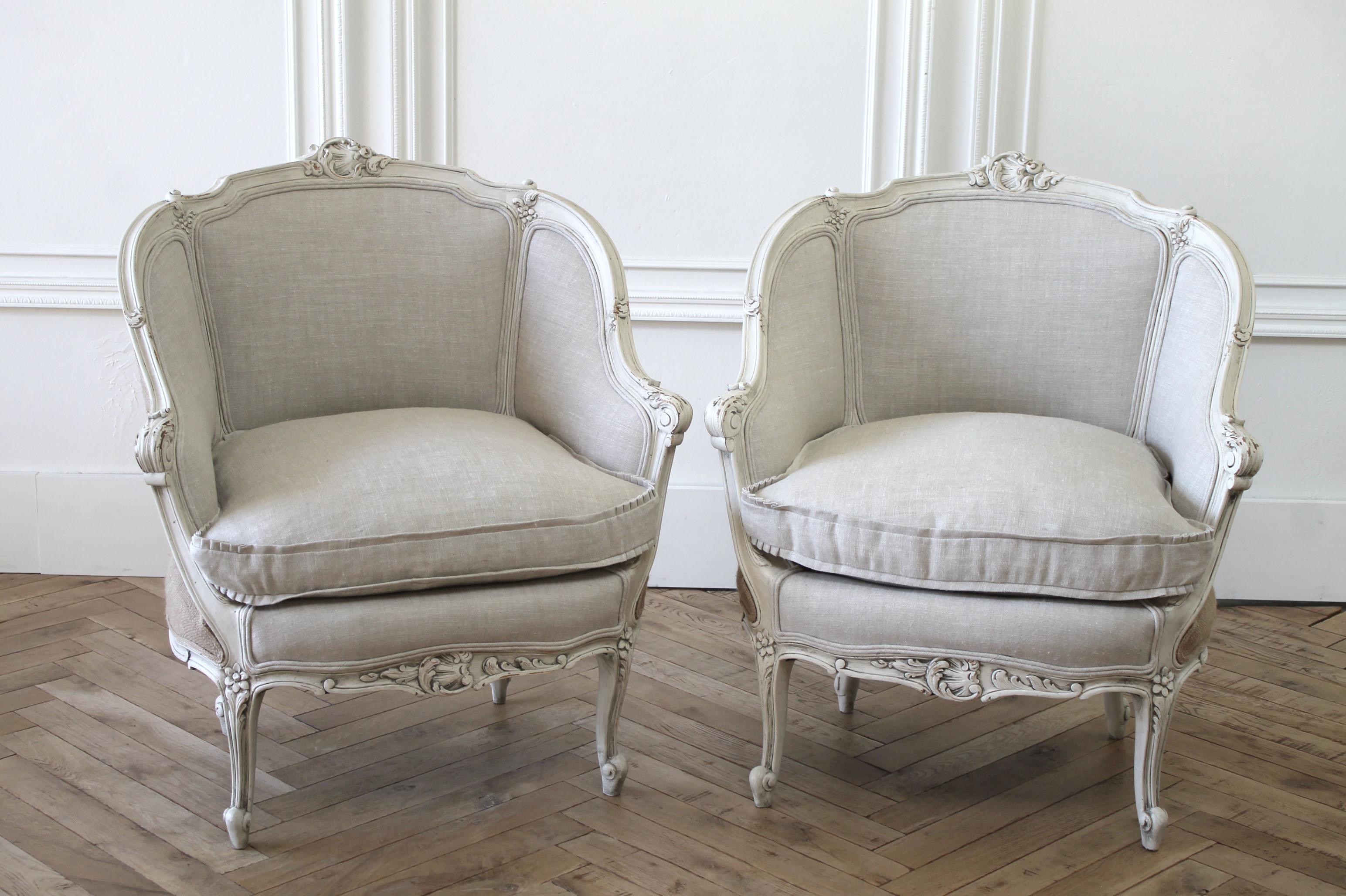 Pair of vintage painted and upholstered French style Marquis chairs in Linen
Painted in a pretty off white, with subtle distressed edges, and antique patina, these chairs have bee reupholstered in a beautiful natural Belgian linen. New down wrapped