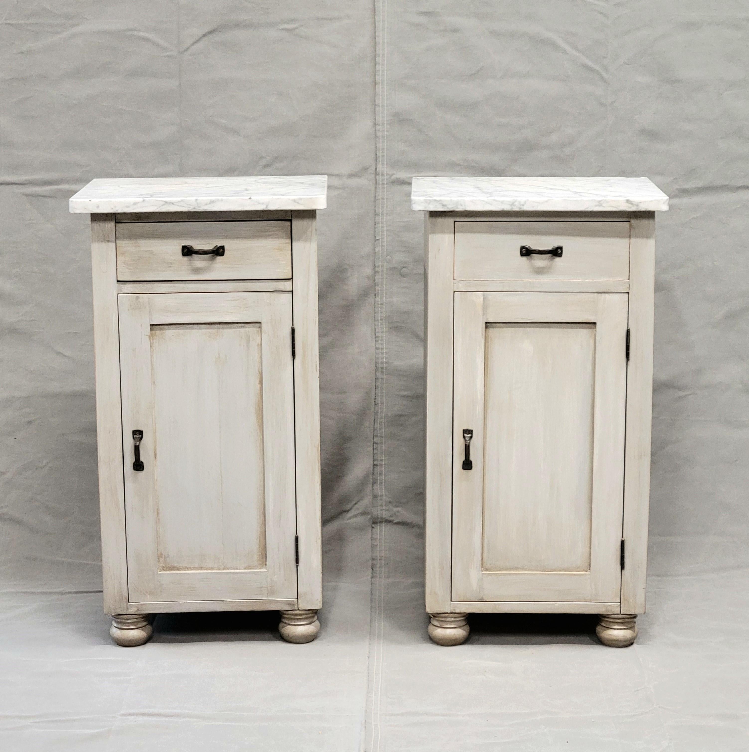 A beautiful and functional pair of rustic farmhouse style nightstands. Crafted of pine shiplap and painted in a pale grey. Removable old carrera marble tops. Old brass hardware. Paint is recent and applied in the antique manner so there are no