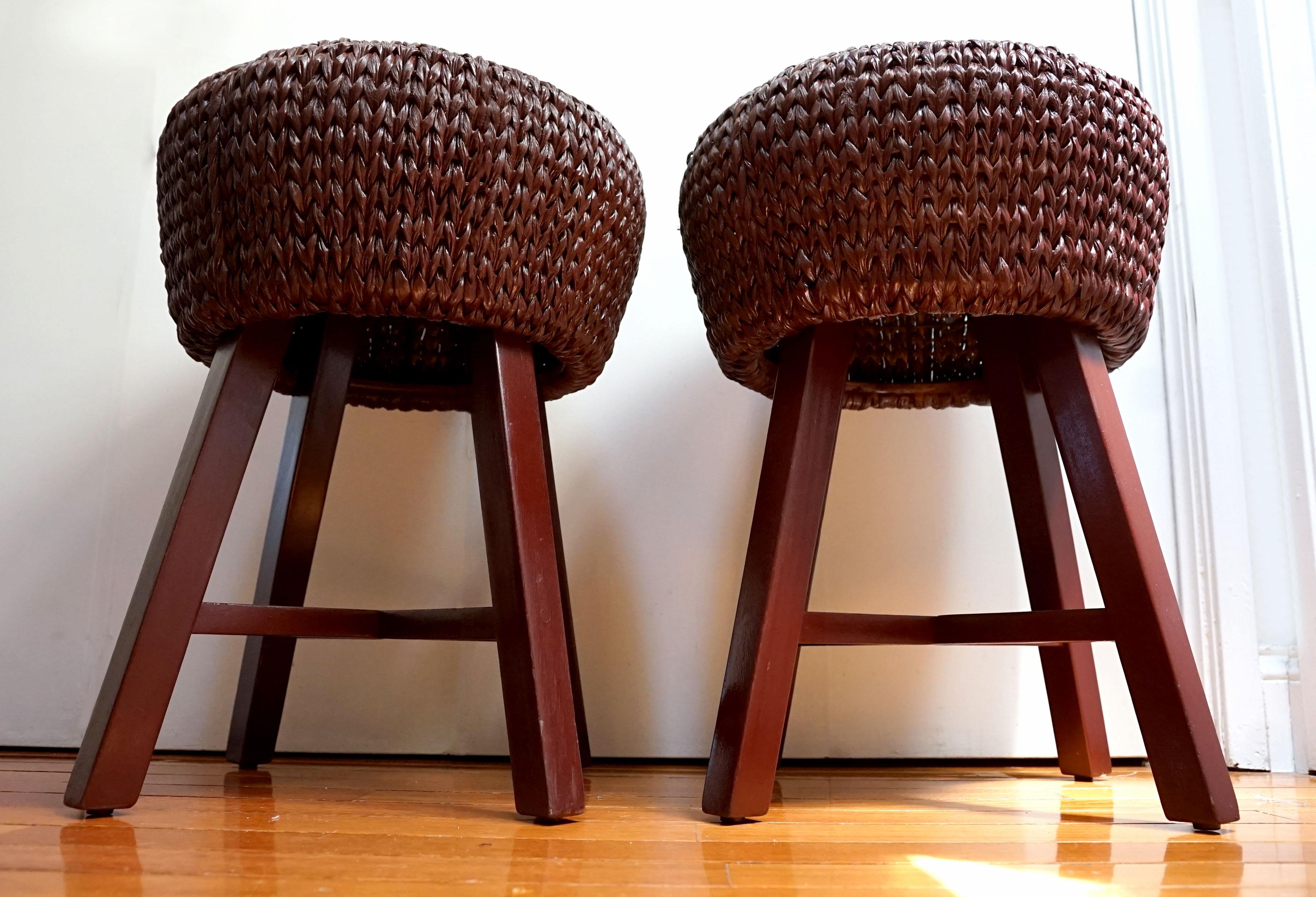 This pair of Palacek bar stools is smashing in deep chocolate leather with a painted finish. The pieces have been reimagined and reupholstered from their vintage gray leather and tan rattan to this chic seating option, almost like new.  The