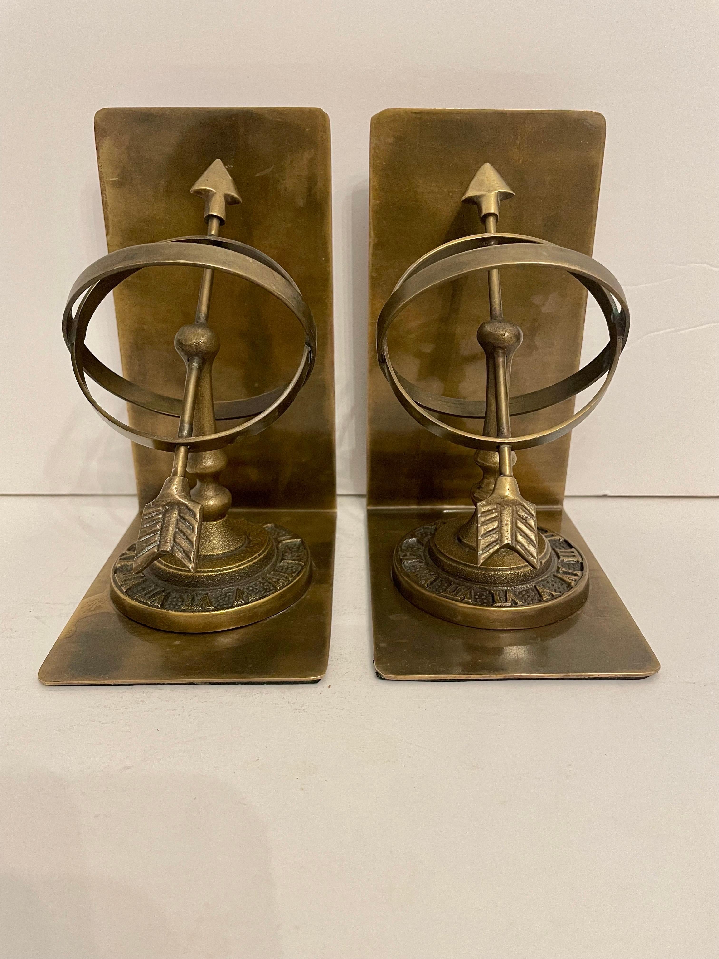 Pair of Vintage Patinated Brass Armillary Bookends. Roman numerals around base. Thin felt on bottom to prevent scratching. Good overall condition. Ready to use. Light and dark areas are reflection in photos.