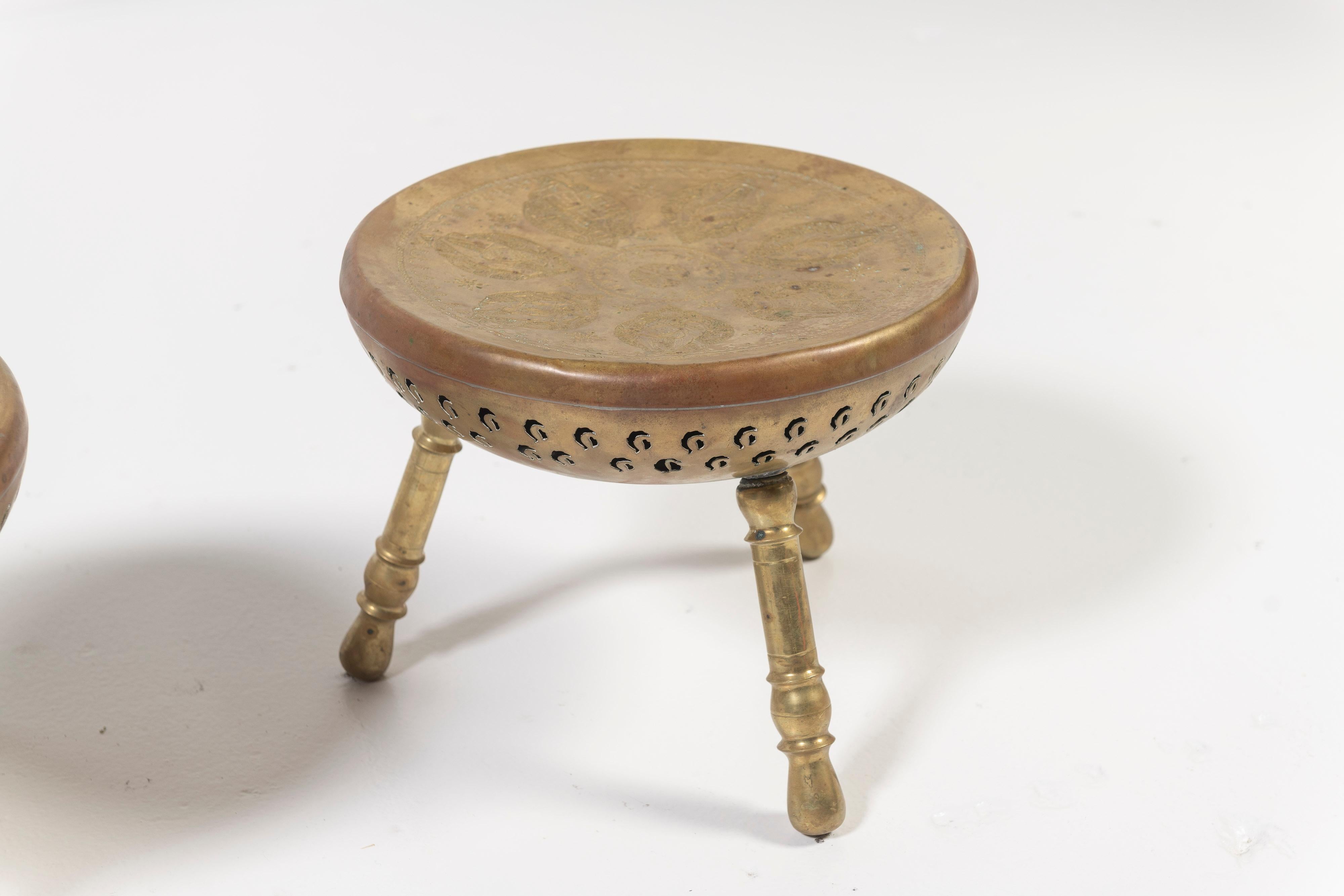 Pair of 19th Century brass brazier foot stools, or foot warmers, with floral motif top and 3 legs each.  Foot warmers were used to provide warmth under the feet in carriages or unheated churches. Originally from Iran (referenced as Nader Persia as