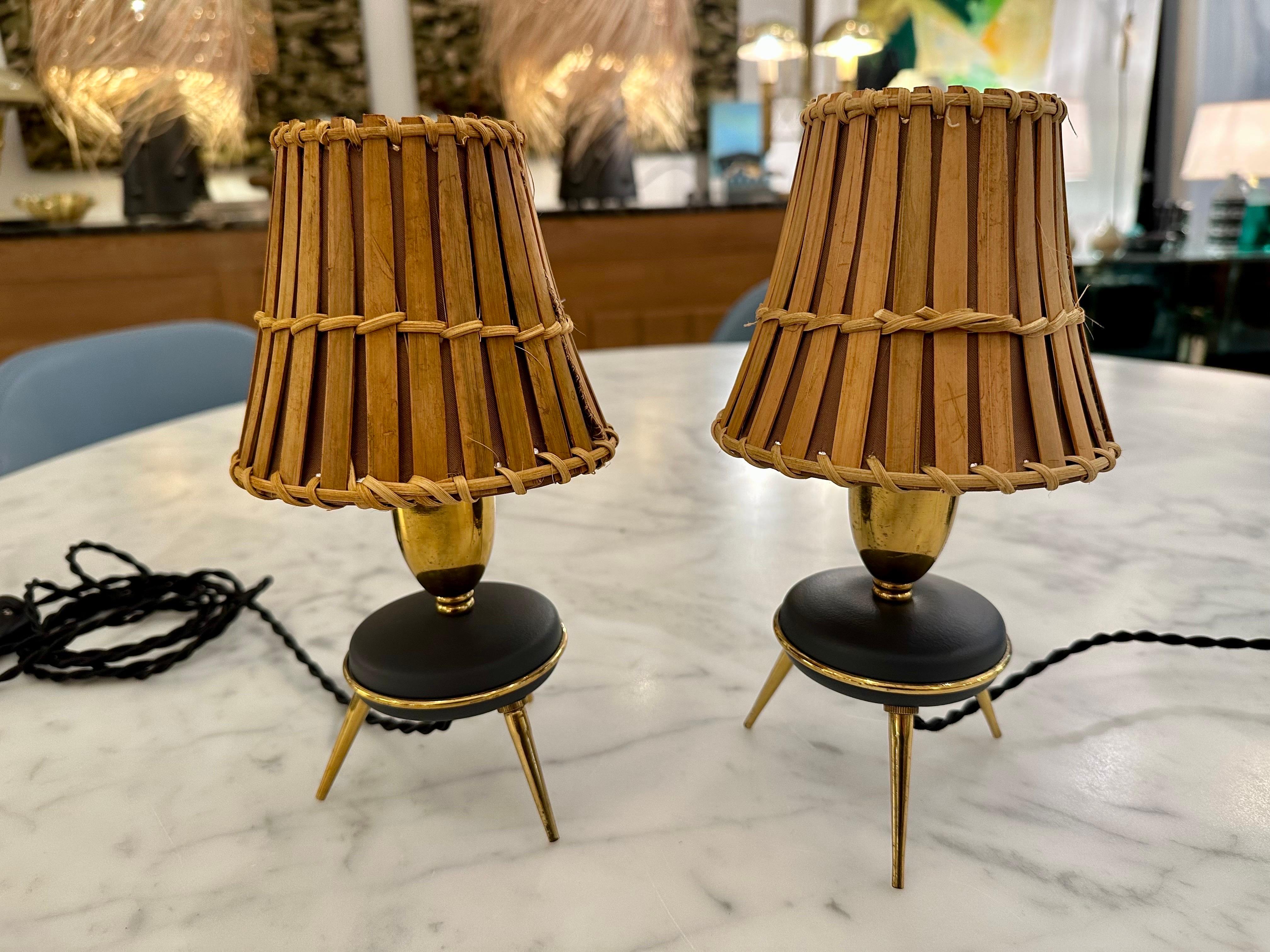 These are simply stunning little table lamps with brass trio legs and brass trim to metal saucer style body.  They have been professionally restored with new twisted black silk cable and switch, new rattan and bamboo shades to enhance these