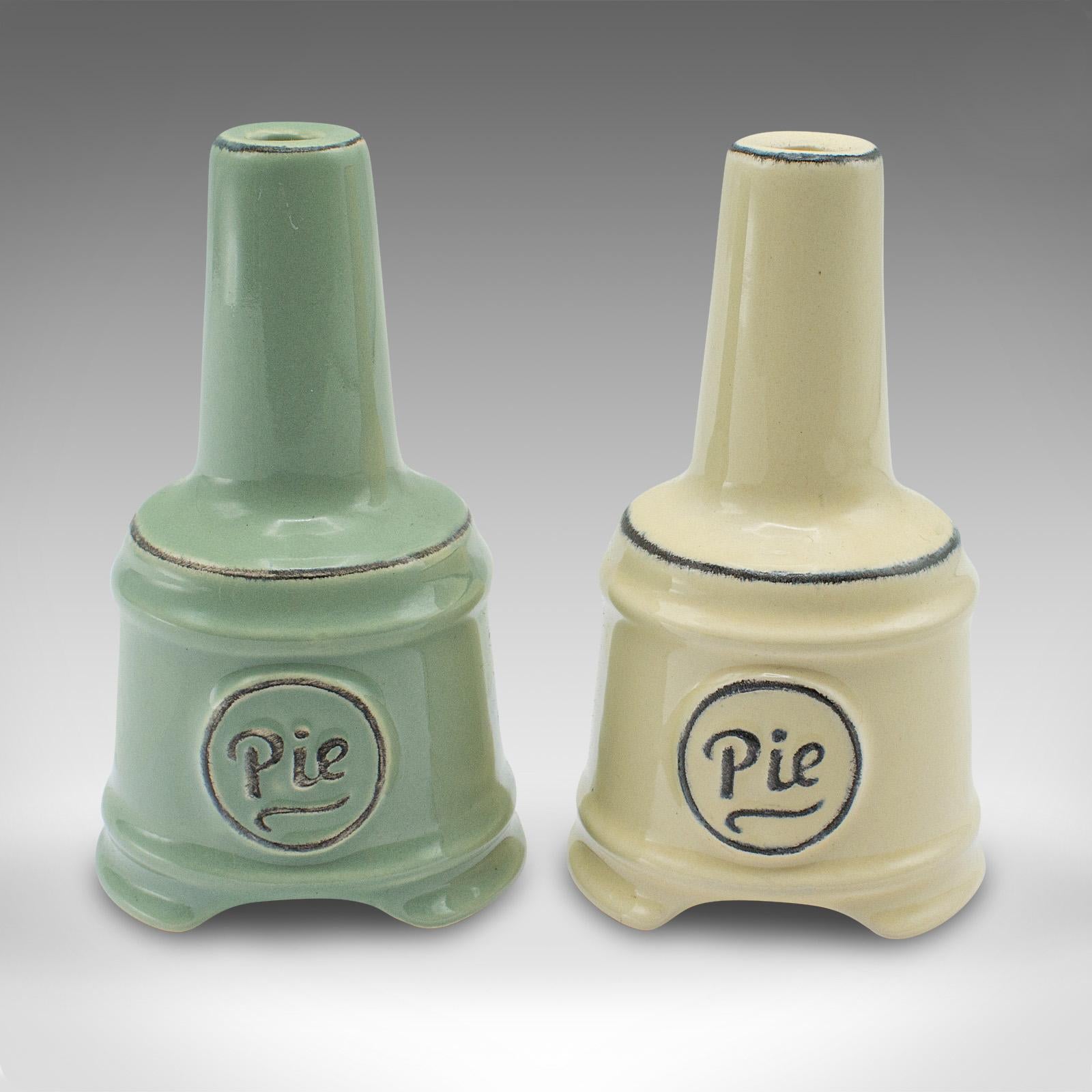 
This is a pair of vintage pie funnels. An English, ceramic bakery steam vent, dating to the mid 20th century, circa 1960.

Charmingly colourful funnels with an appealing decorative finish
Displaying a desirable aged patina and in very good