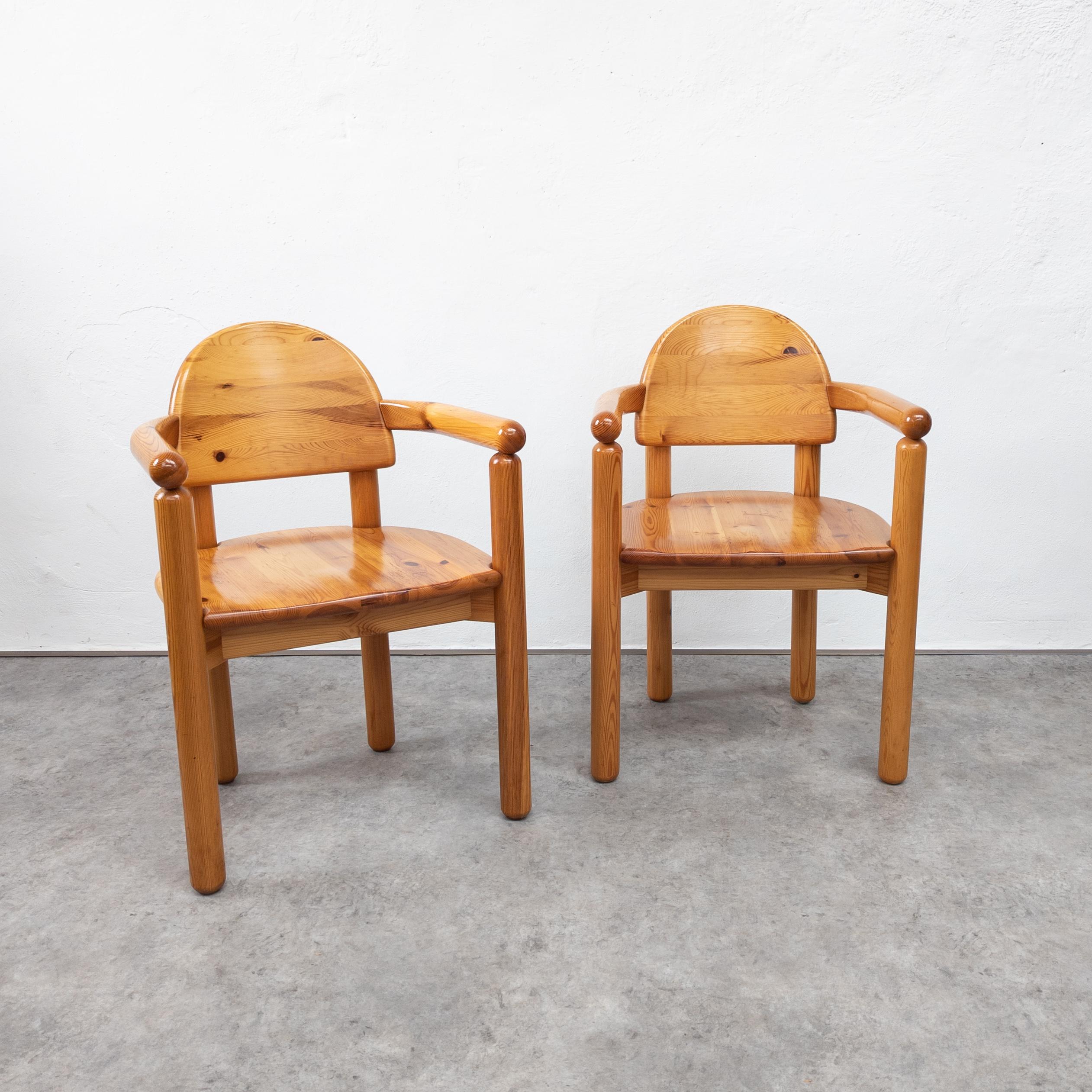 Set of 2 dining chairs / armchairs by Danish architect Rainer Daumiller for Hirtshals Sawmill, Denmark, 1970s. Made of solid lacquered pine wood with beautiful texture. Organically designed dining chairs with curved backrest which fluently runs into