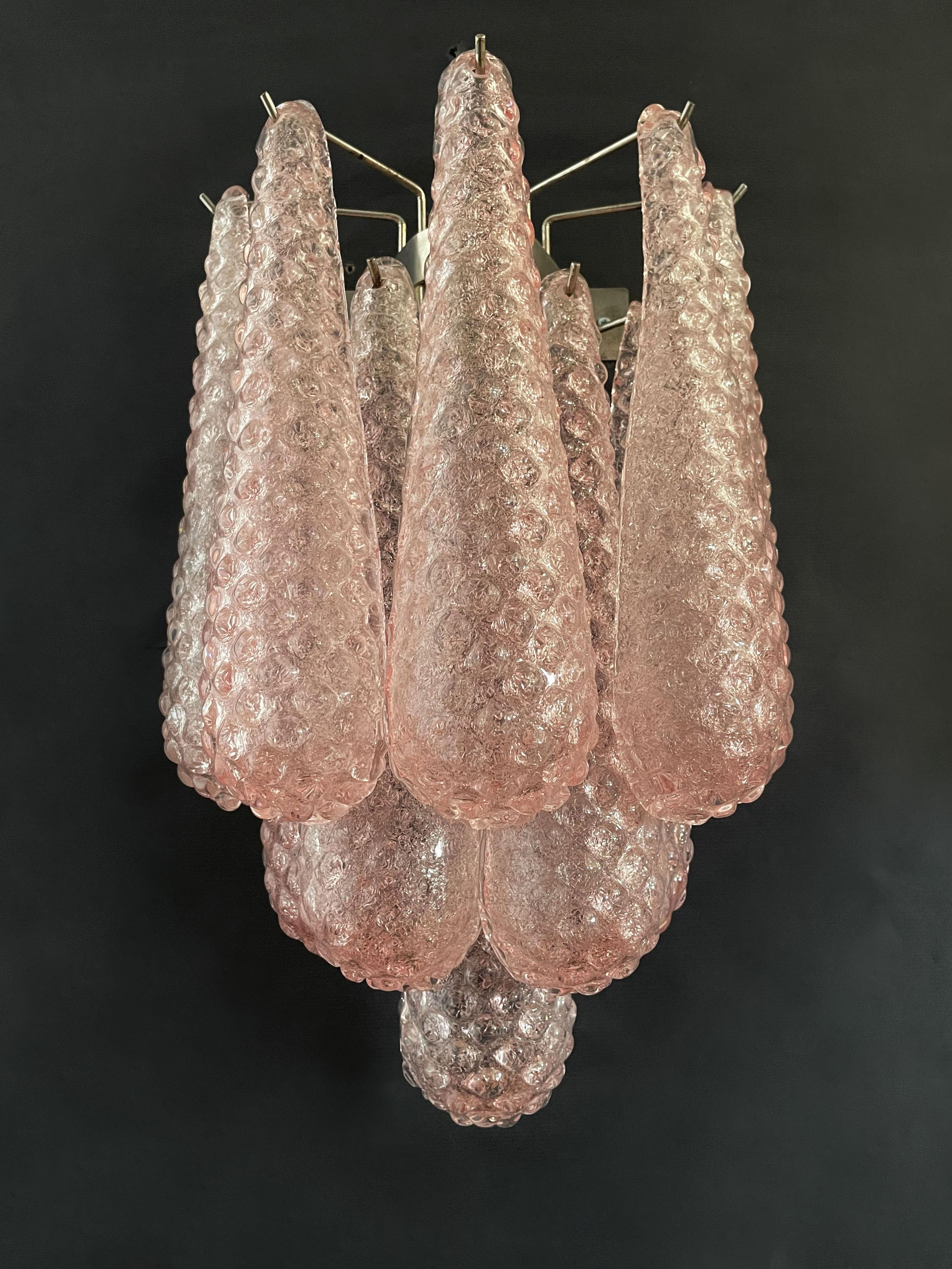 Fantastic pair of vintage Murano wall sconce made by 10 pink glass petals (transparent crystal, smooth outside, with crystal powder and then rough inside) in a chrome frame.
Period: late XX century
Dimensions: 17,70 inches height (45 cm); 13,40