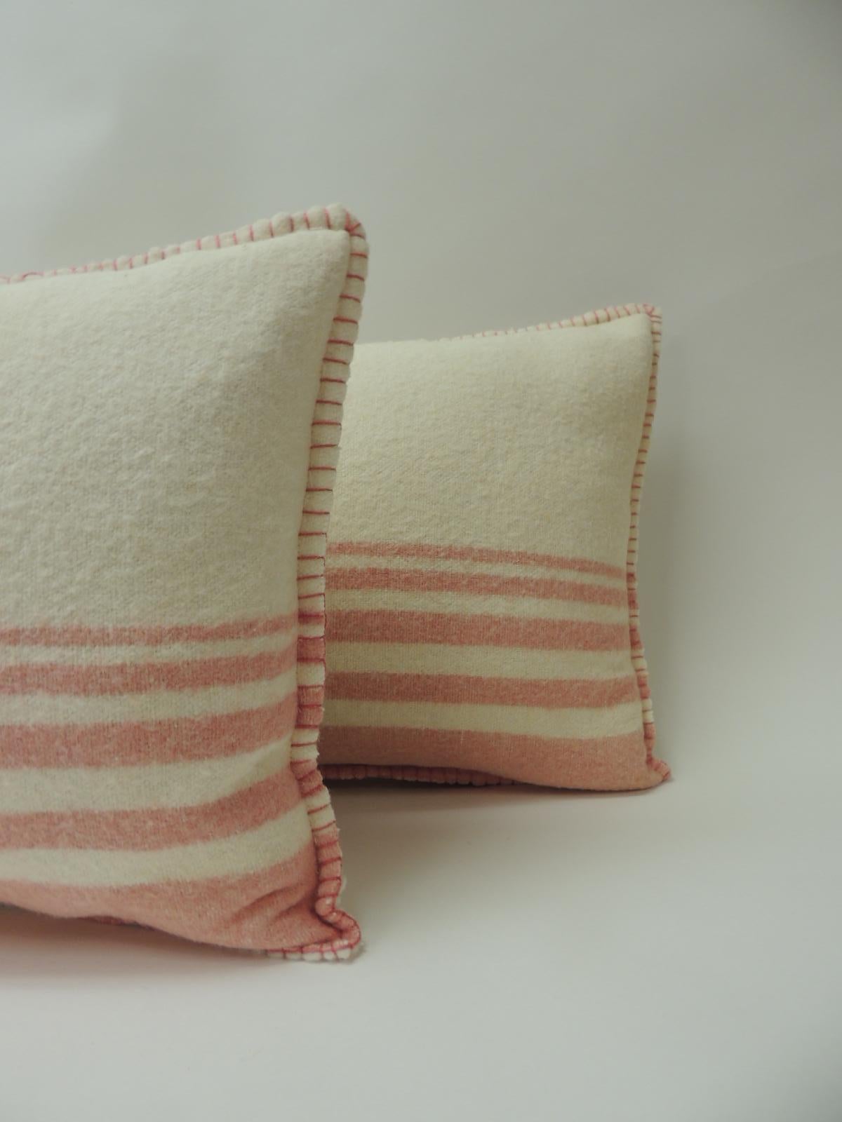 Pair of Vintage Natural & Pink Stripes English Wool Decorative Lumbar Pillows.
These pillows were hand-crafted and designed from an old English blanket using the border as a front and the solid field as backings. Decorative pillows embellished with