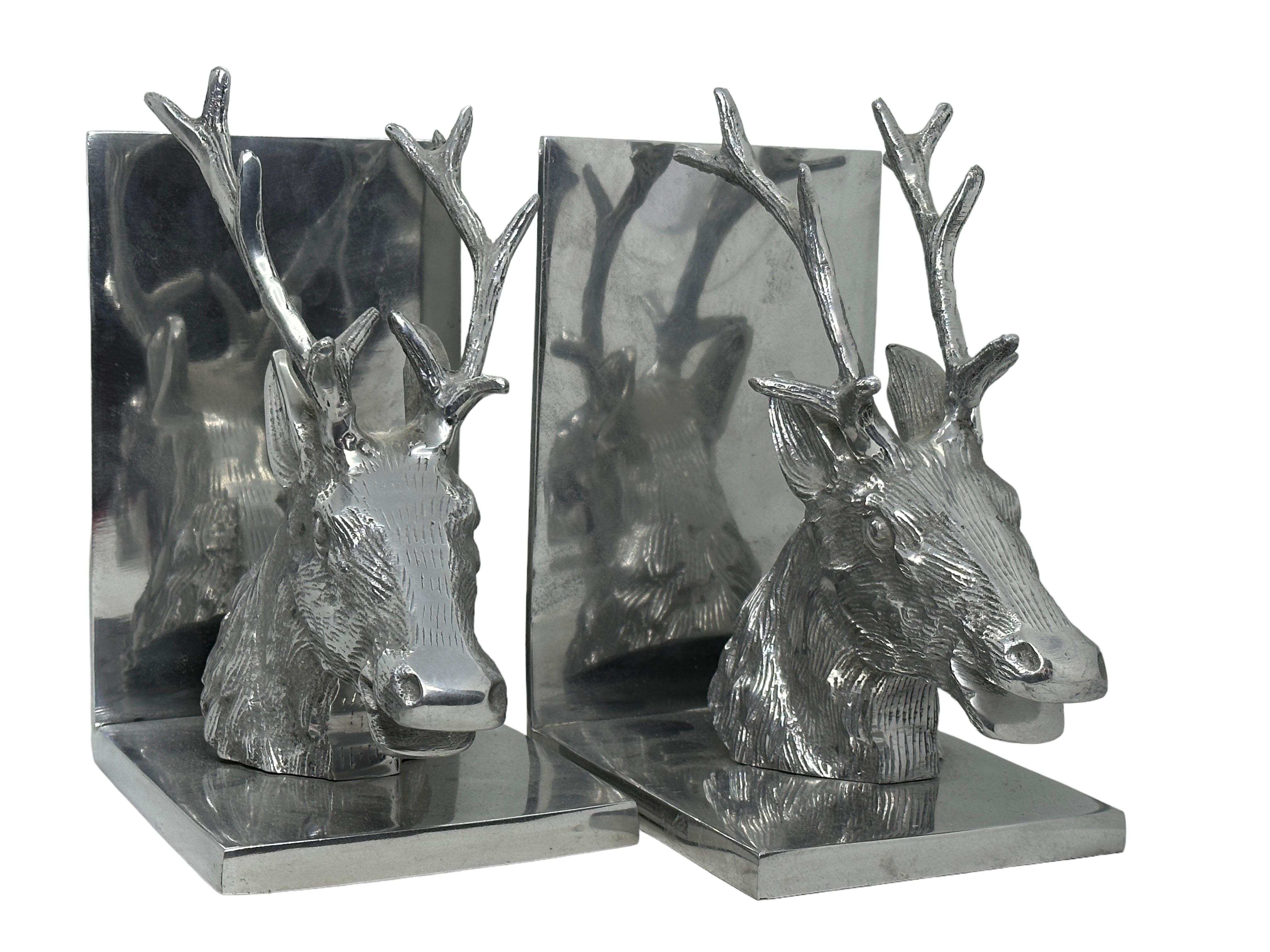 Vintage pair of polished aluminum deer bookends, circa 1980s. Pair of polished decorative bookends in realistic style. Very sturdy and heavy. Great for holding up books on a bookshelf or as paper weights on a desk or decorative animal sculptures