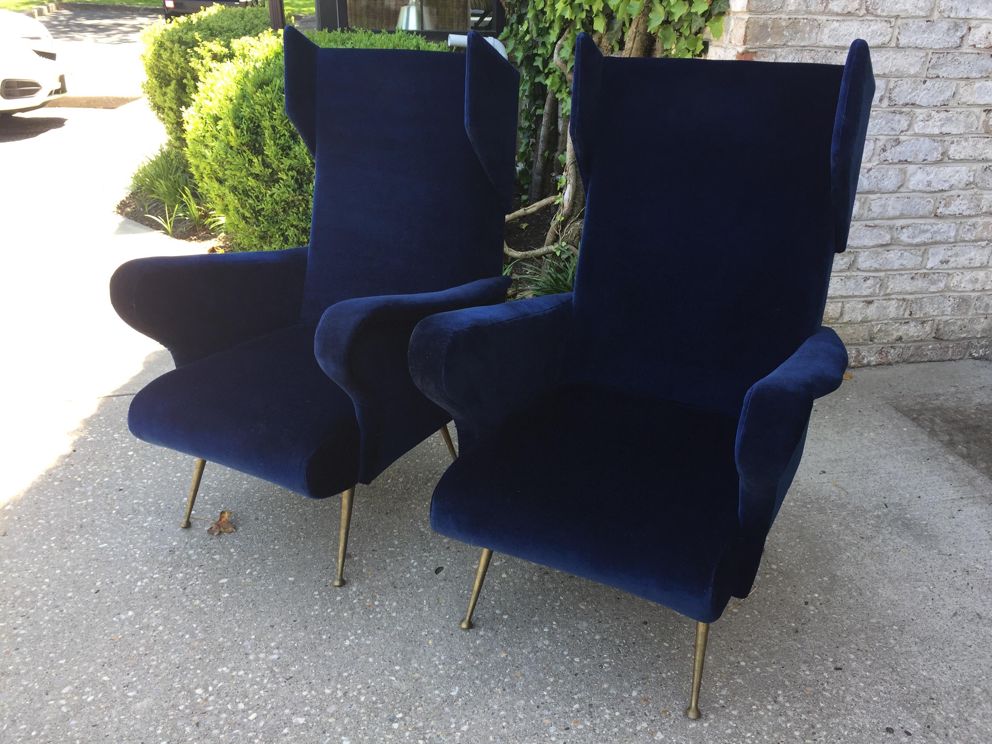 Great scale and futurist winged headrest in the style of Ponti. Upholstered in Indigo Blue velvet, acquired in France in current condition. Brass feet are classic vintage Italian design.
