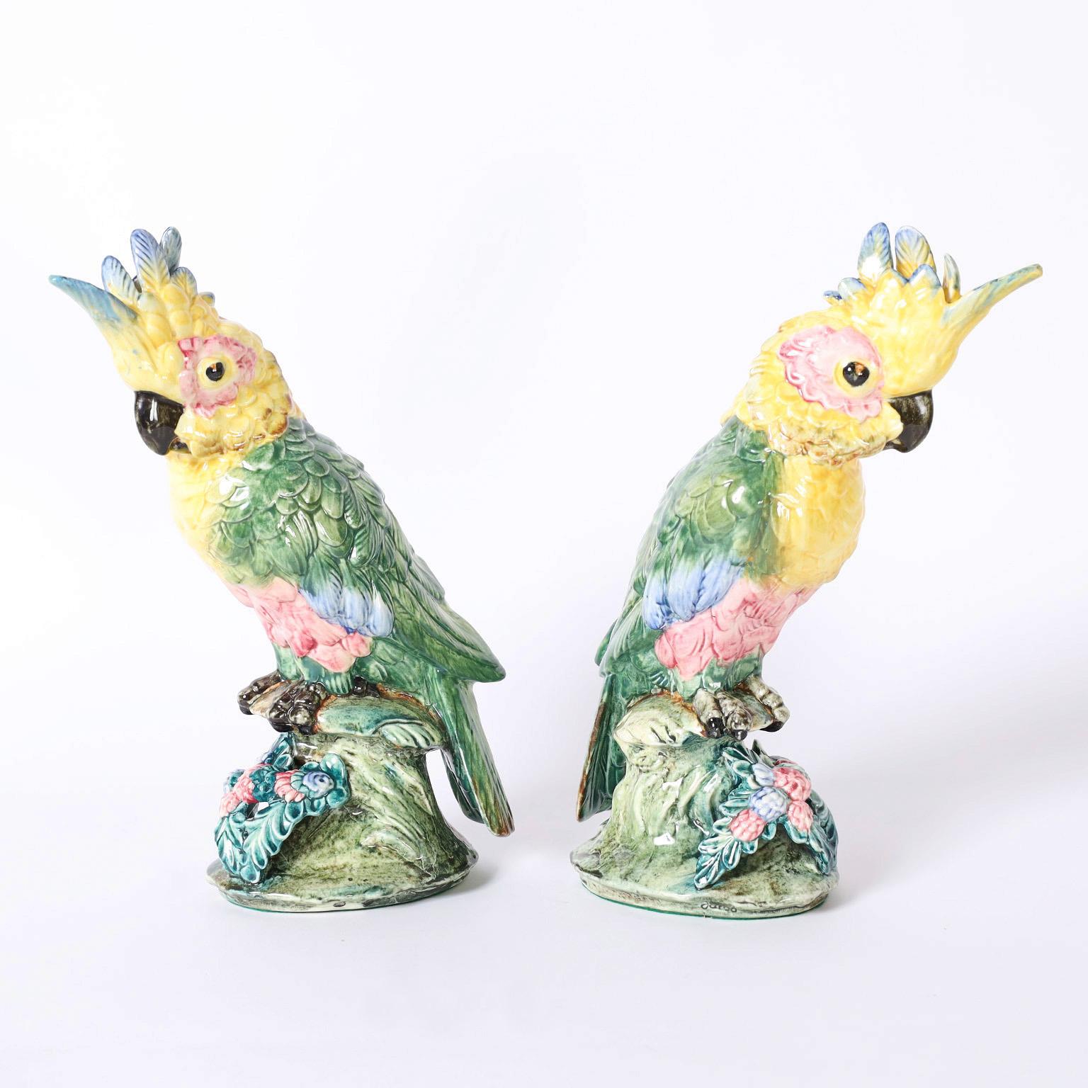 Delightful pair of cockatoos crafted in porcelain and decorated in bold tropical colors signed Stangl Pottery on the bottoms.