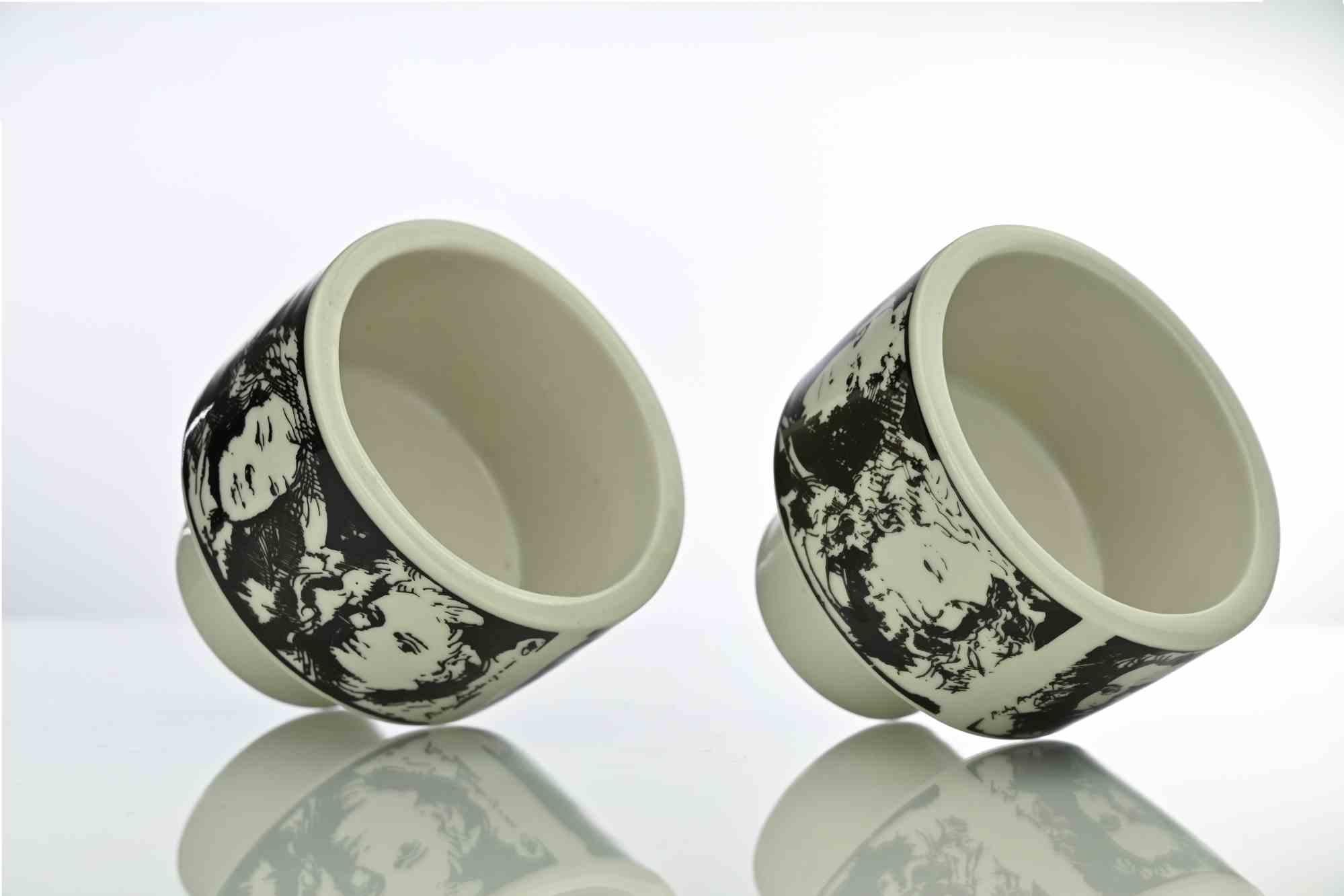 Pair of vintage cups designed by the italian artist Pietro Annigoni and produced in Italy in 1980s.

Ceramics are surrounded by screen print images realized by the artist.

Very good condition.
