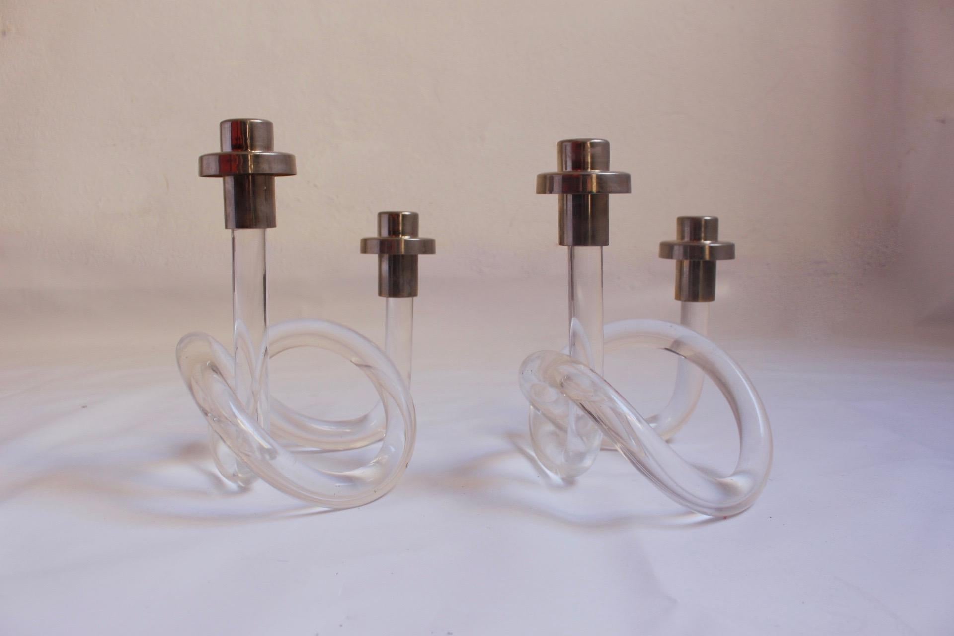 Set of 2 Lucite and chrome double candlestick holder designed by American designer Dorothy Thorpe, circa 1960s.
 Single piece bent and twisted acrylic to form the base which is often referred to as the Pretzel.
 