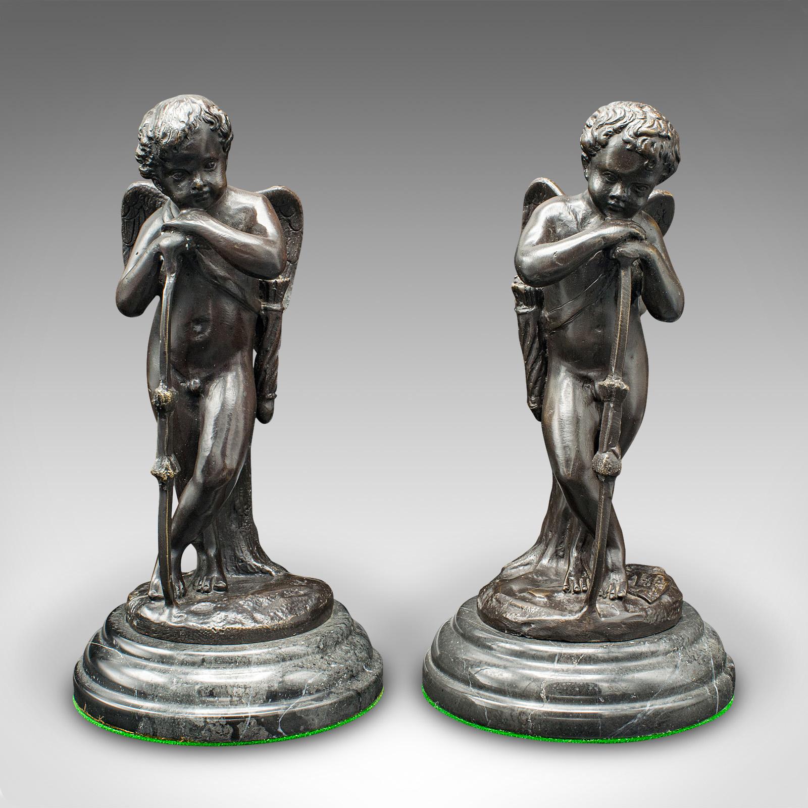This is a pair of vintage putti figures. A French, sculpted bronze over marble decorative cupid ornament after Auguste Moreau, dating to the Art Deco period, circa 1930.

Charming cherub figures, with forlorn pose at rest
Displaying a desirable aged