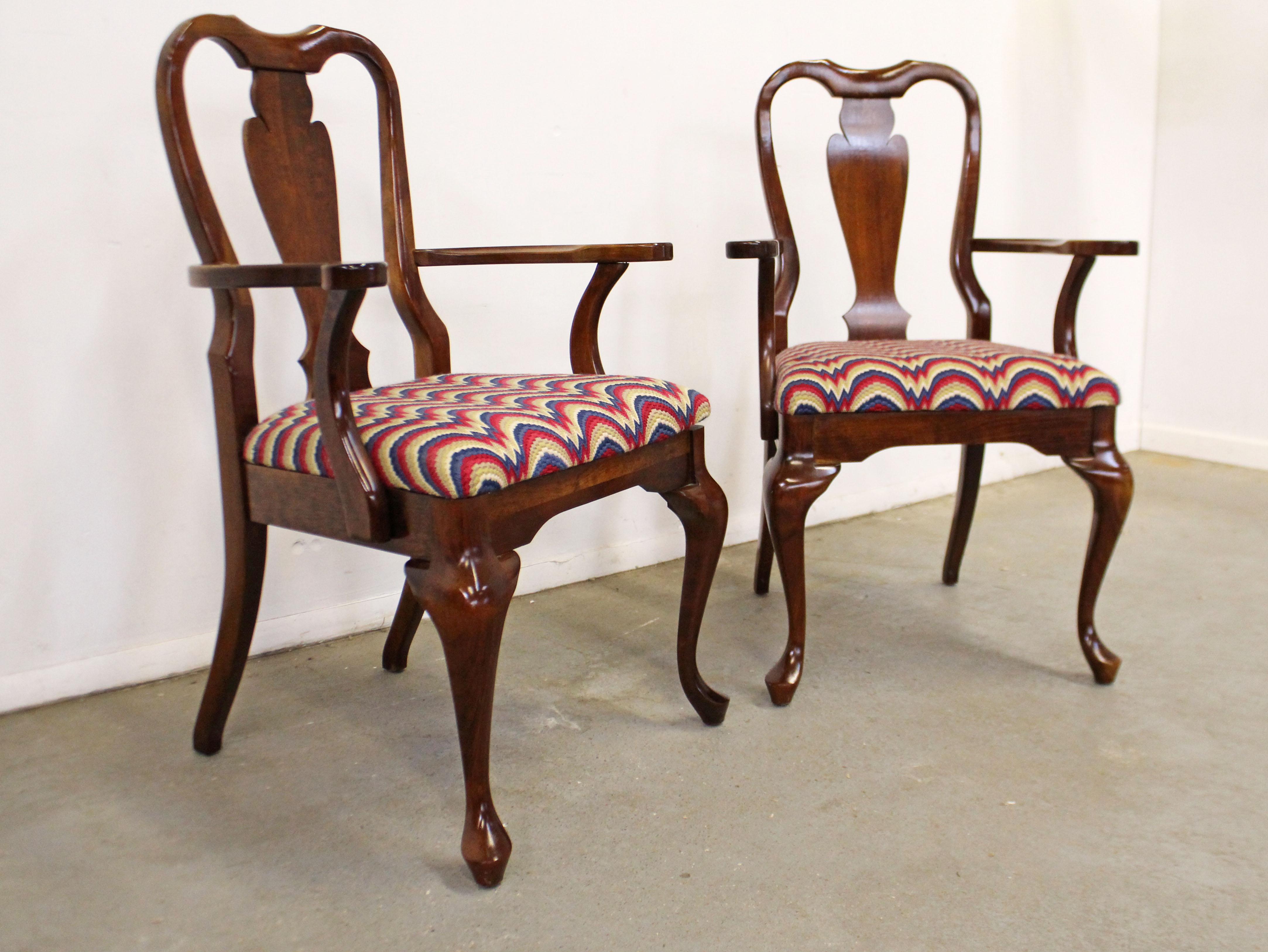 Offered is a pair of vintage Queen Anne armchairs. They are made of solid cherry wood and have knit upholstered seats. In very good condition for their age, with some slight surface scratches/wear on the wood. The upholstery is in good condition, no