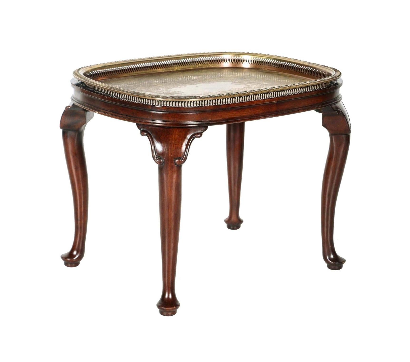 An elegant pair of vintage Queen Anne style mahogany tray top side tables. Each table features a rectangular top with rounded corners and raised, molded edges. A removable brass tray with raised pierced edges can be placed on top. The brass tray has