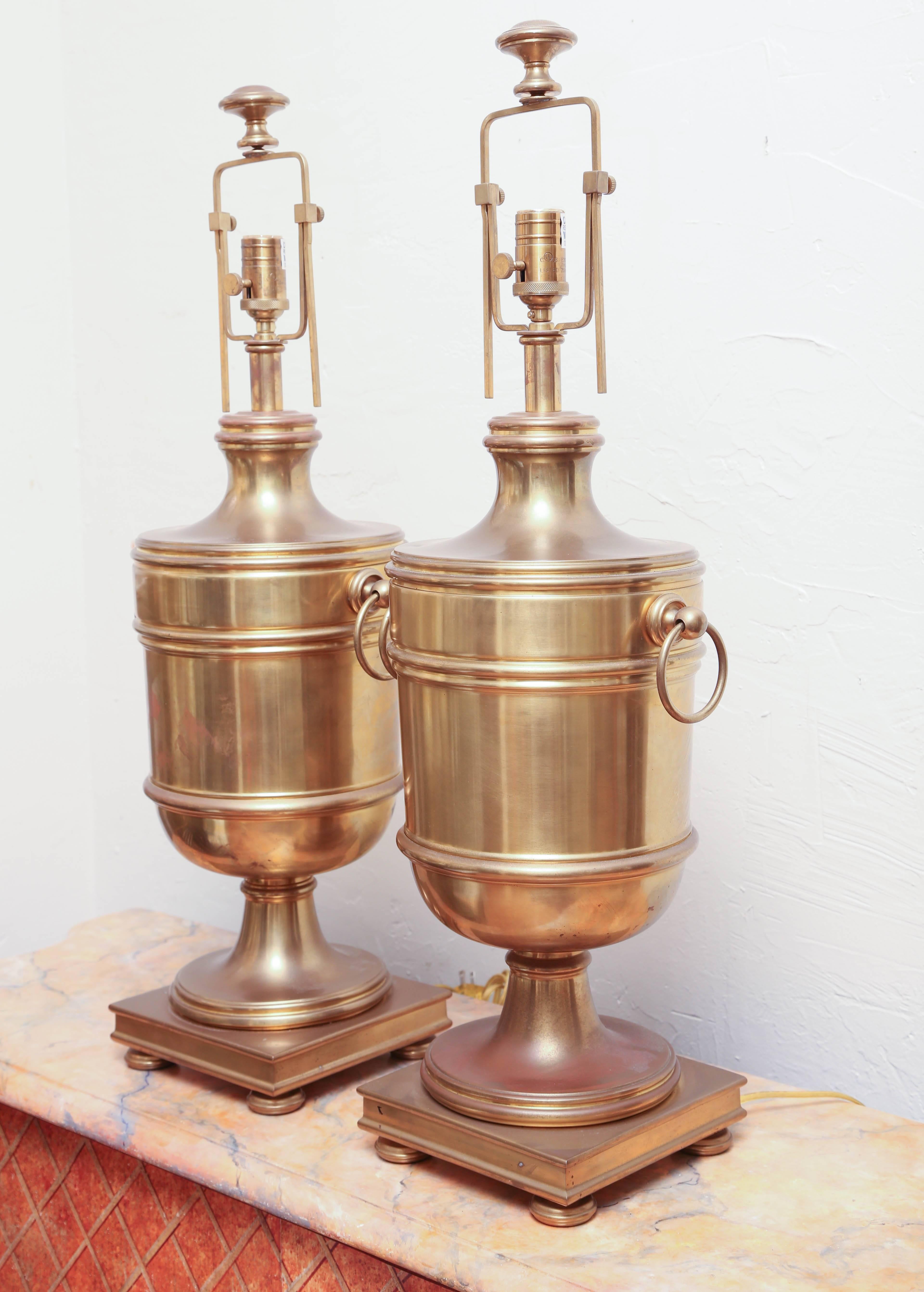 Large pair of brass urn lamps with adjustable harps by Ralph Lauren.