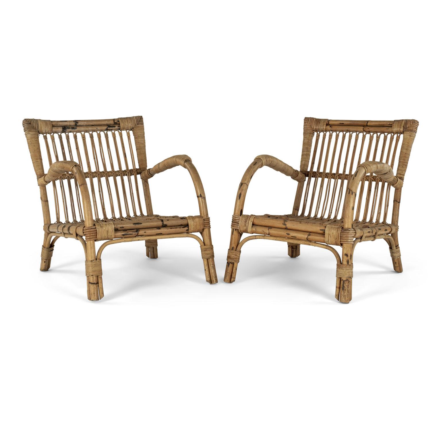 Pair of vintage rattan lounge armchairs from France. Measure H 28.5 in x W 25 in x D 33.5 in (seat is H 12 in x W 20 in x D 22 in and arms are H 21.5 in). Sold together as a pair and priced $2,400. Pictured in last photo with rattan sofa (Item ref.