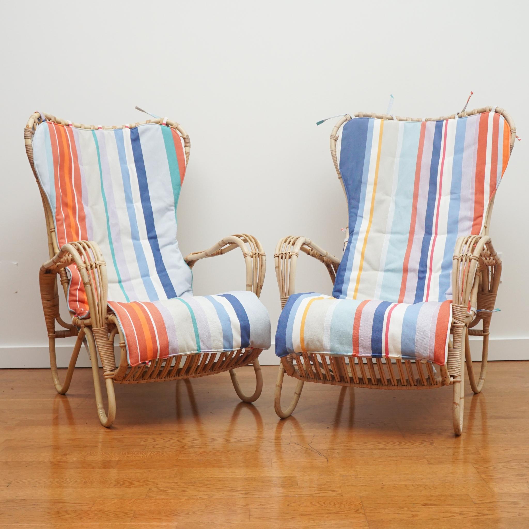 This pair of rattan lounge chairs are new arrivals from Sweden. Made in the 1950s both chairs are in remarkably good condition showing no major signs of wear, damage or repair. We did replace the original tie-on seat cushions with a summery stripe