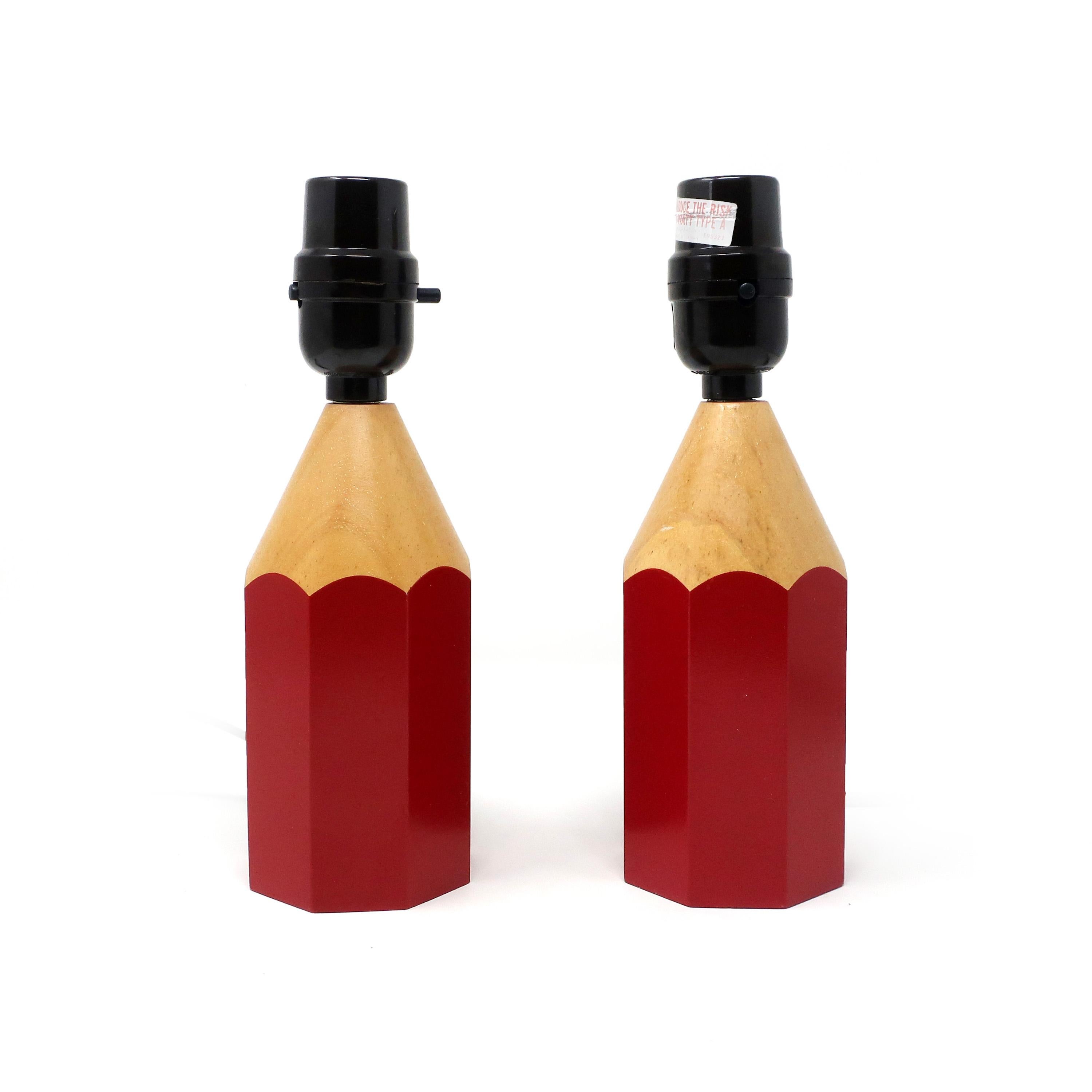 A pair of vintage Lightolier pencil lamps with original shades. Perfect size for a desk or table lamp and a design fun enough to work anywhere in your home, for the living to an office to kids’ bedrooms. Base is red pencil shape with wood tips,