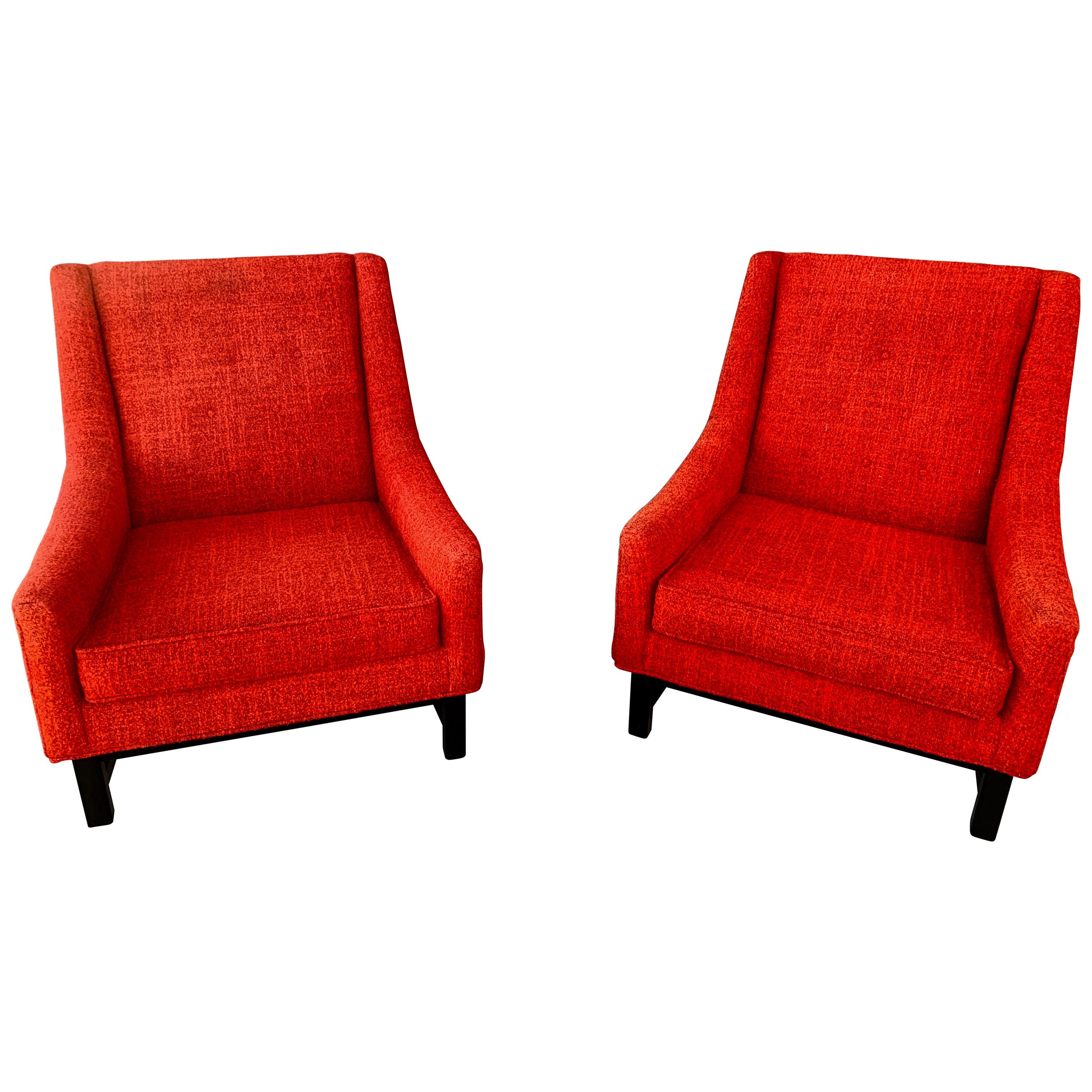 A nice looking pair of vintage red lounge or club chairs with painted oak bases. These chairs have the look of Dunbar or Adrian Pearsall but no labels as they have been re-upholstered at some point in the past. The fabric is slightly worn but we