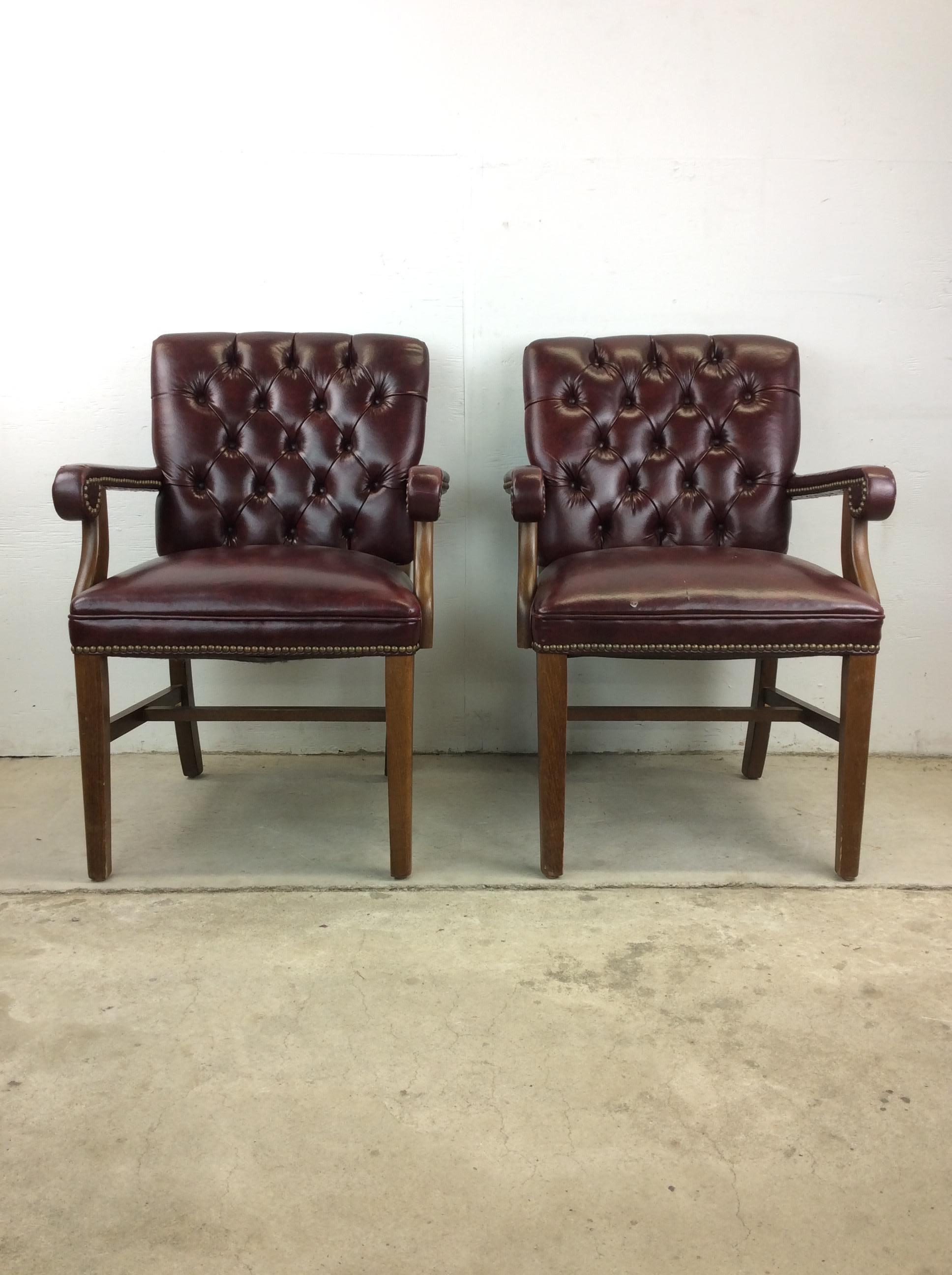 This pair of vintage Chesterfield style arm chairs feature vintage red leather upholstery, tufted seat backs, and hardwood arms and base.

Dimensions: 25w 26d 35h 20sh 25ah

Condition: Upholstery is in good original condition with only some light
