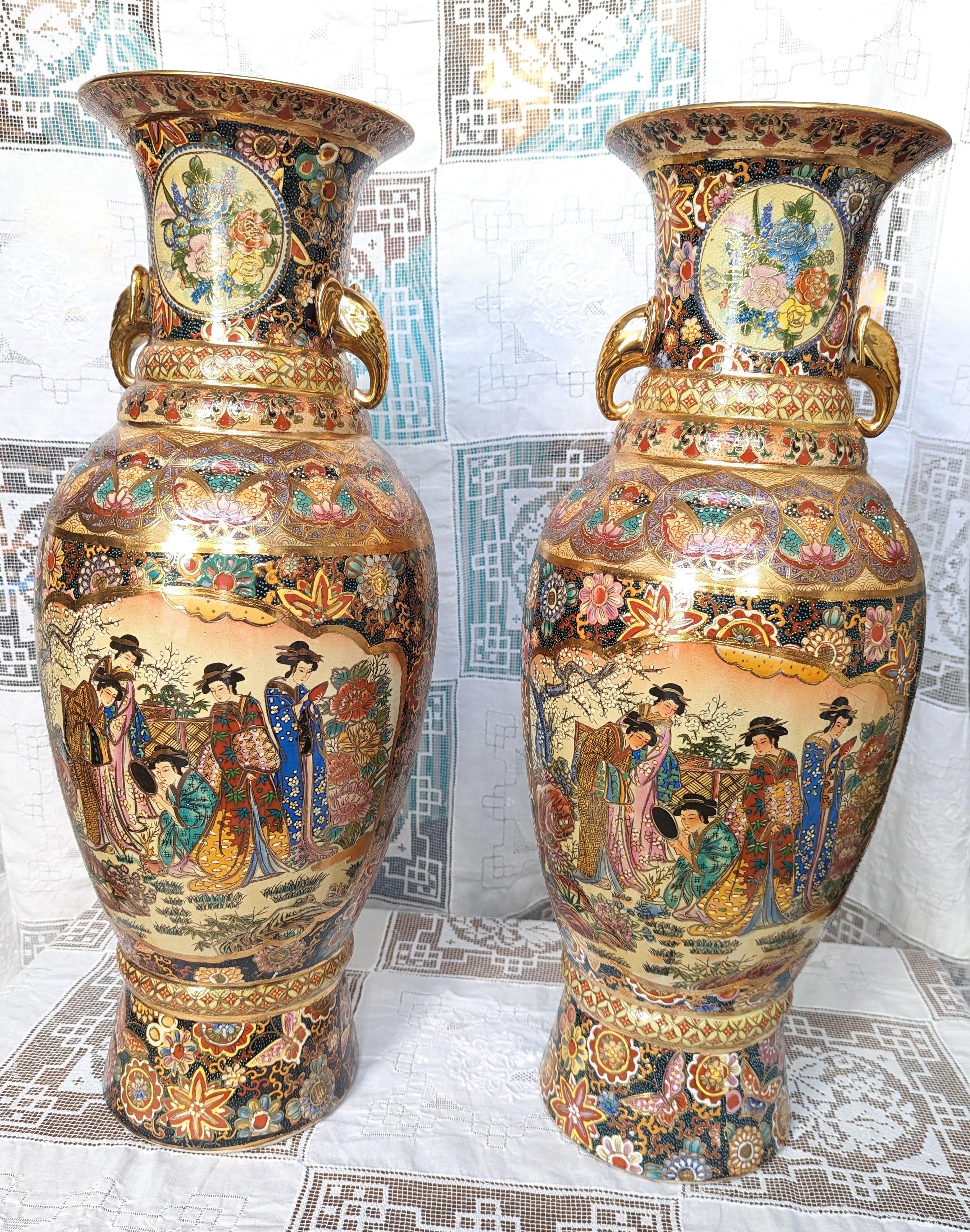 Pair of beautiful and intricately detailed Royal Satsuma vases, moriage and gilt adorn these stunning pieces of art. These tall statement pieces measure 24