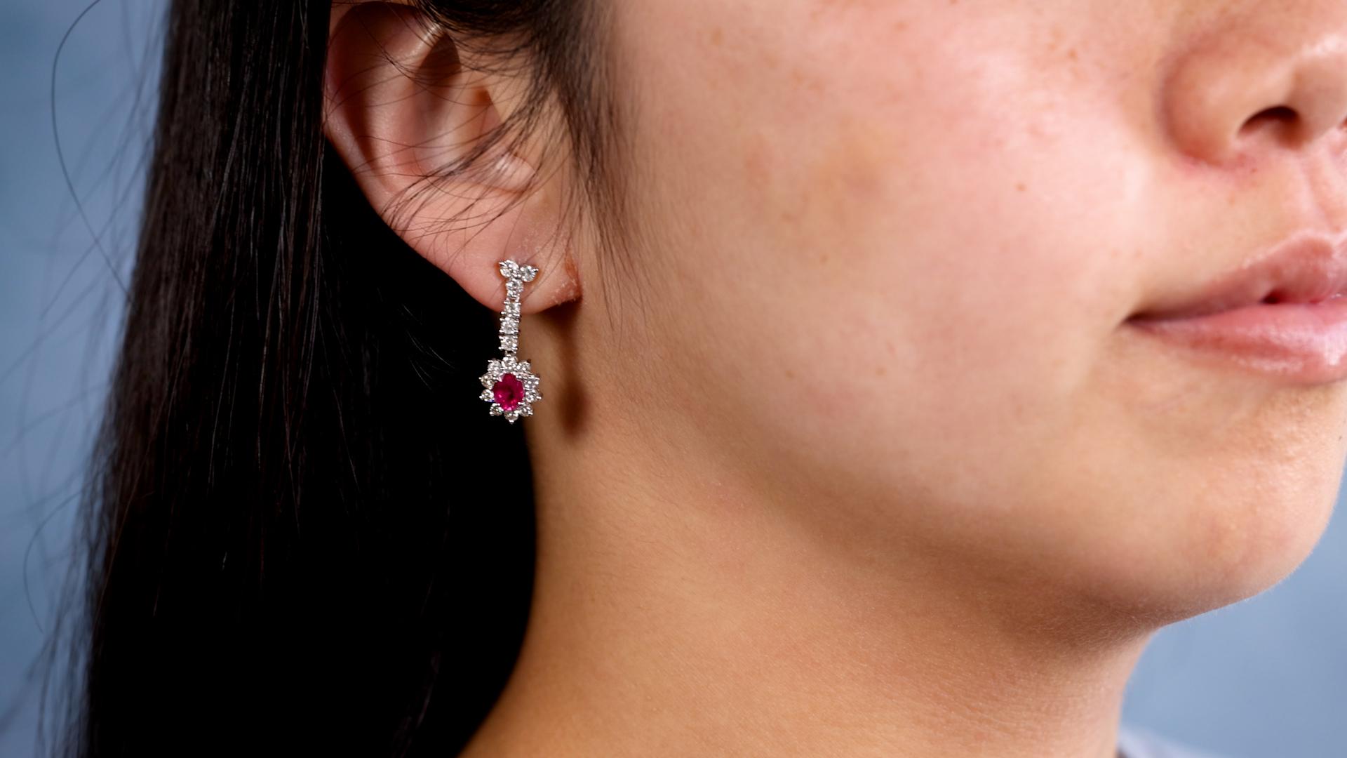 Ein Paar Vintage Rubin Diamant 18k Weißgold Tropfen Ohrringe. Mit zwei ovalen Rubinen im Mischschliff mit einem Gesamtgewicht von 1,50 Karat. Akzentuiert durch 32 runde Diamanten im Brillantschliff mit einem Gesamtgewicht von 1,02 Karat, eingestuft