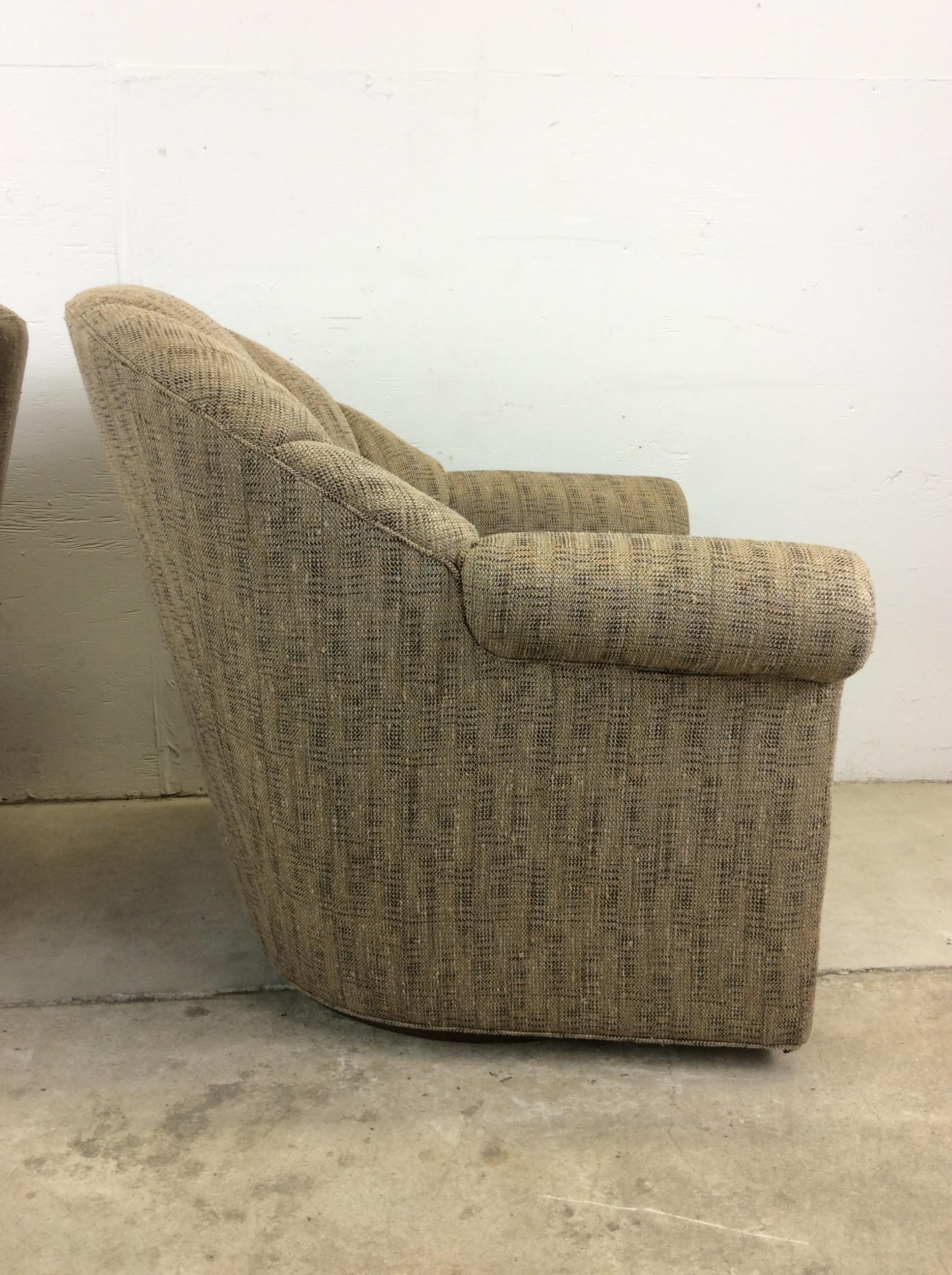 This pair of vintage barrel back club chairs by Oskar Huber feature vintage patterned upholstery, scalloped back, removable cushions and swivel base.

Dimensions: 35w 38d 33.5h 19sh 23ah

Condition: Original upholstery has some discoloration.  It