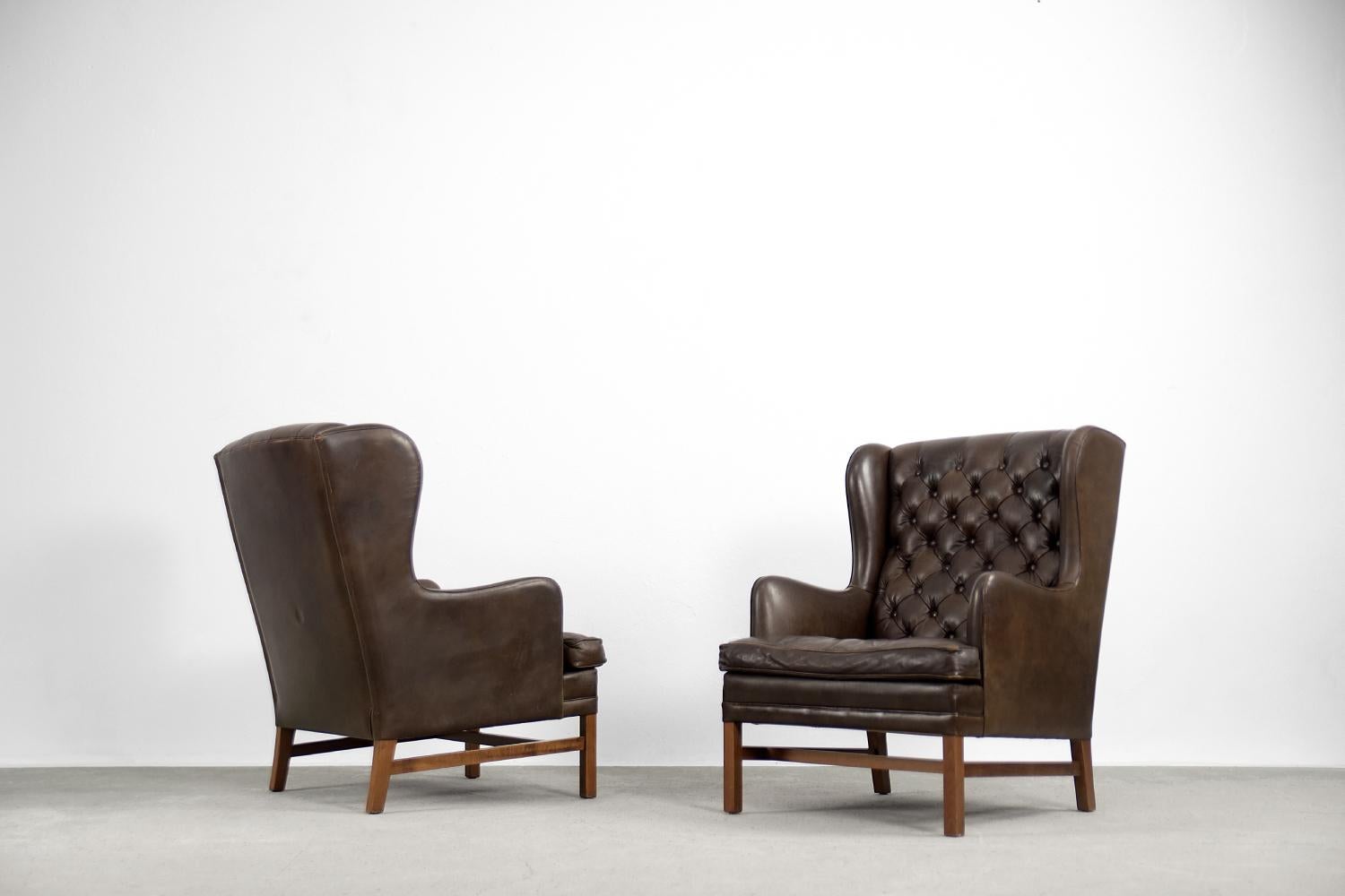 This set of two quilted wing chairs was manufactured in Sweden by OPE Möbler during the 1960s. The armchairs were upholstered in natural leather in dark chocolate colour. The back is high and contoured. The quilting is made in traditional diamonds