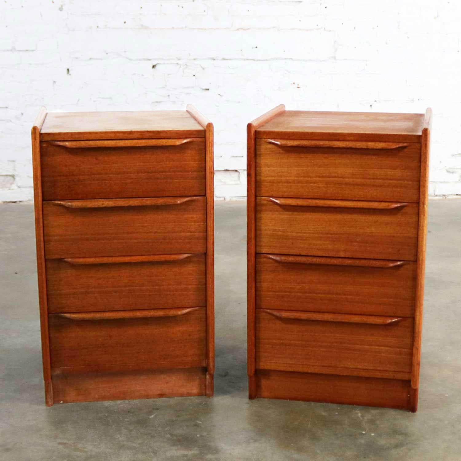 Handsome pair of Scandinavian Modern teak nightstands with four drawers each and mounted on a kick base. They are also equipped with a bracket for wall hanging. They are in fabulous vintage condition with normal wear for their age, circa 1966.