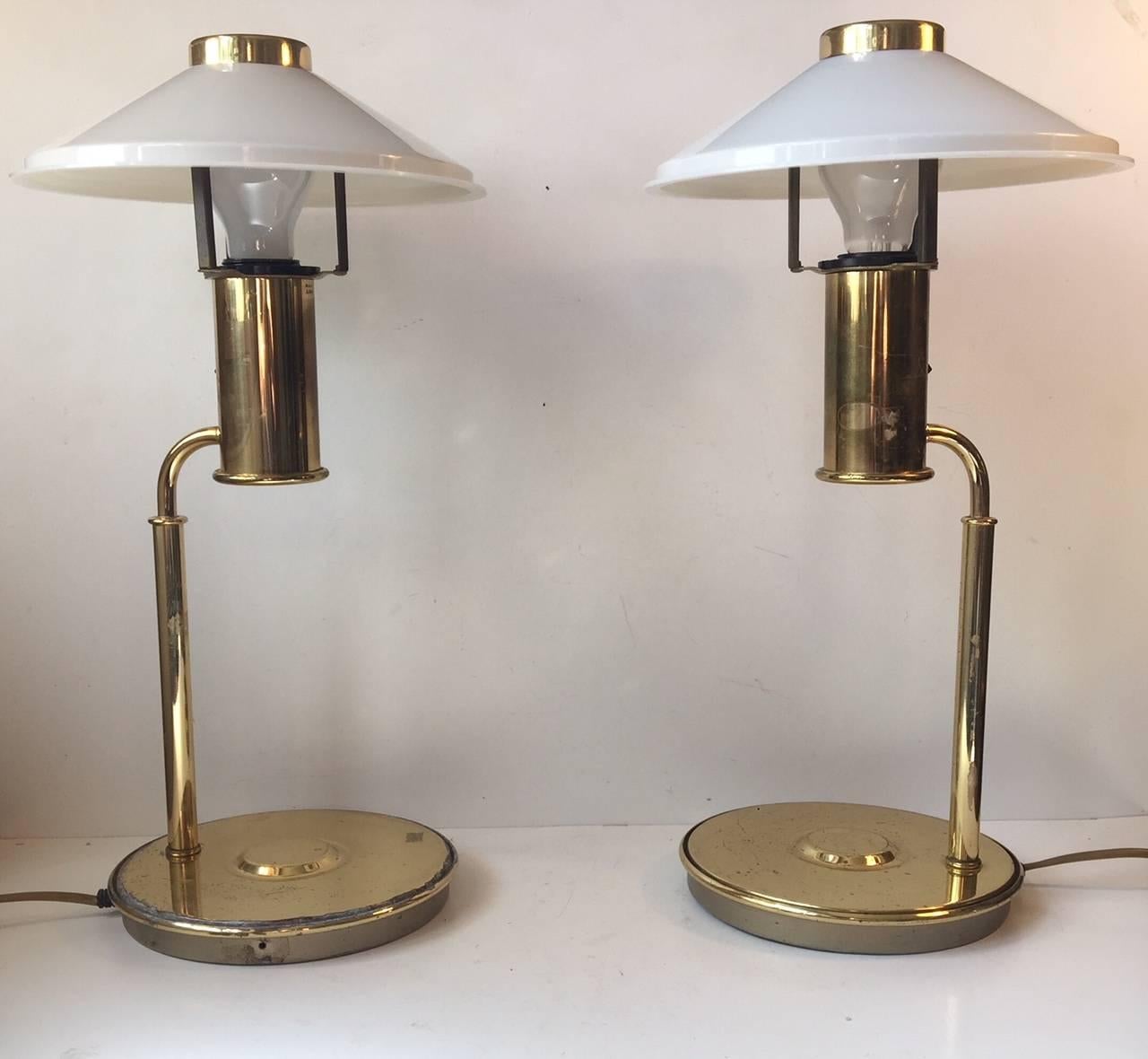 A pair of 1960s Nautical - navy table or desk lamps composed of brass and mounted with acrylic fluorescent shades. These lights comes from a Norwegian Navy ship (No: sjøforsvaret). The HV initials within a crown labelled to the base of each light