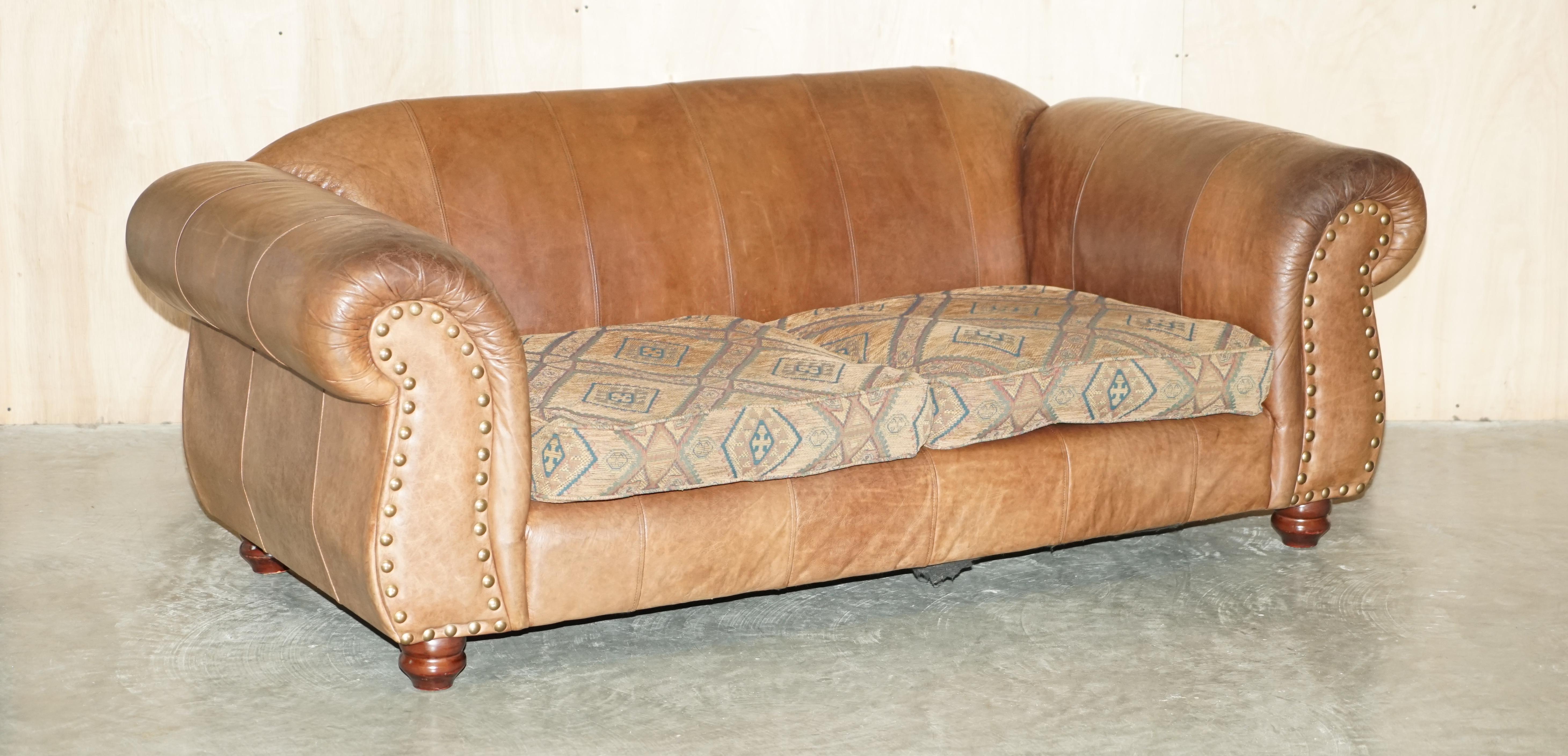 We are delighted to offer for sale this pair of large vintage Thomas Lloyd brown leather with Kilim seat cushion sofas from a rather spectacular Scottish castle 

A very good looking and super comfortable pair of large sofas, they come in heritage