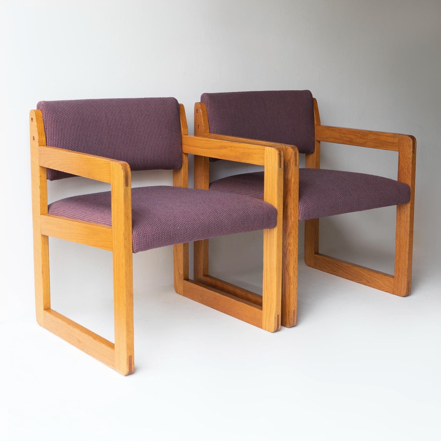 A matching pair of good quality 1970s armchairs.

Sculptural and almost brutalist in design with neat flush joined exposed oak frames.

Extremely comfortable with generous seats upholstered in the original purple woven fabric.

Unsigned but