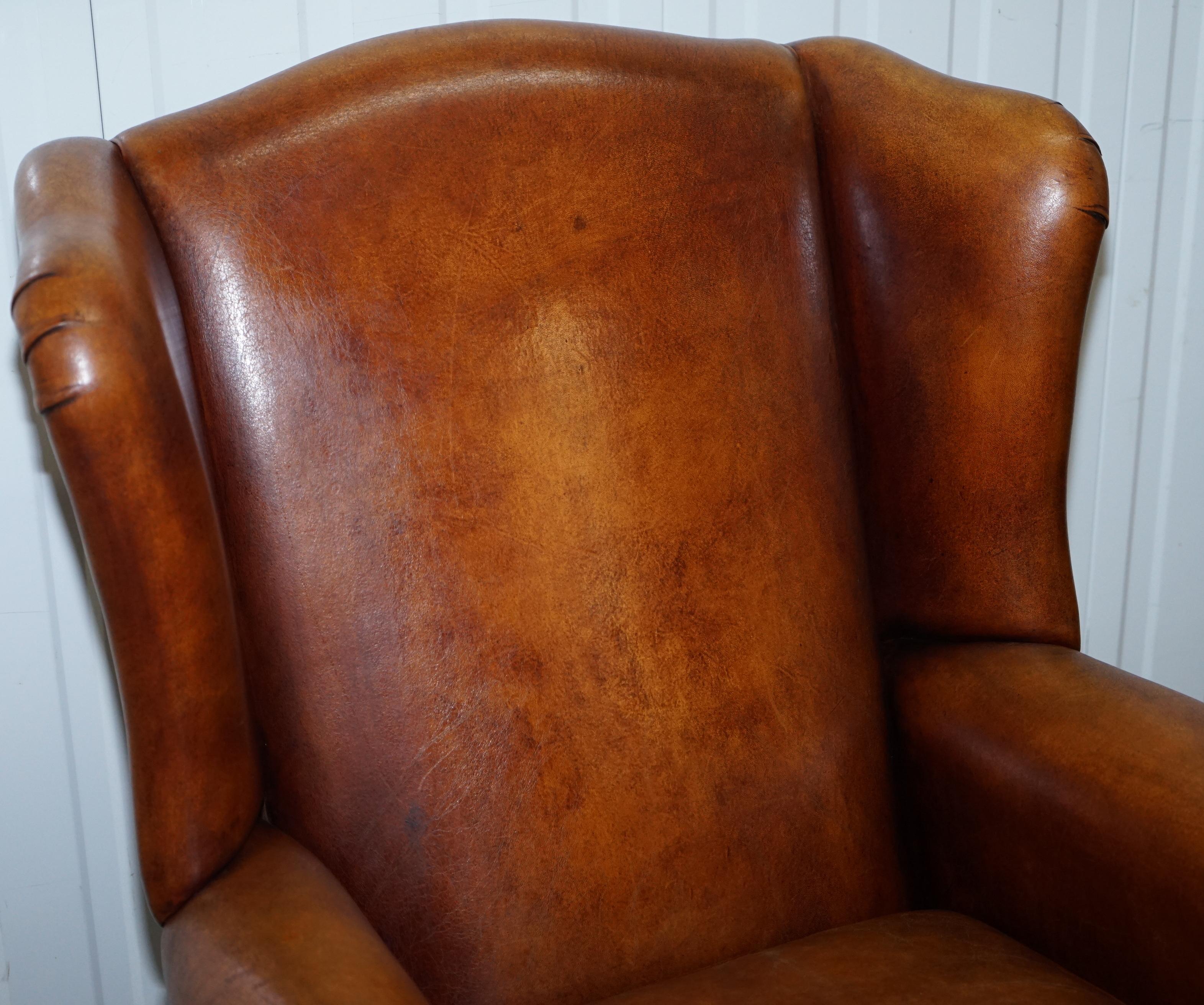 Hand-Carved Pair of Vintage Sheepskin Leather Aged Brown Wingback Armchairs Carved Wood Legs