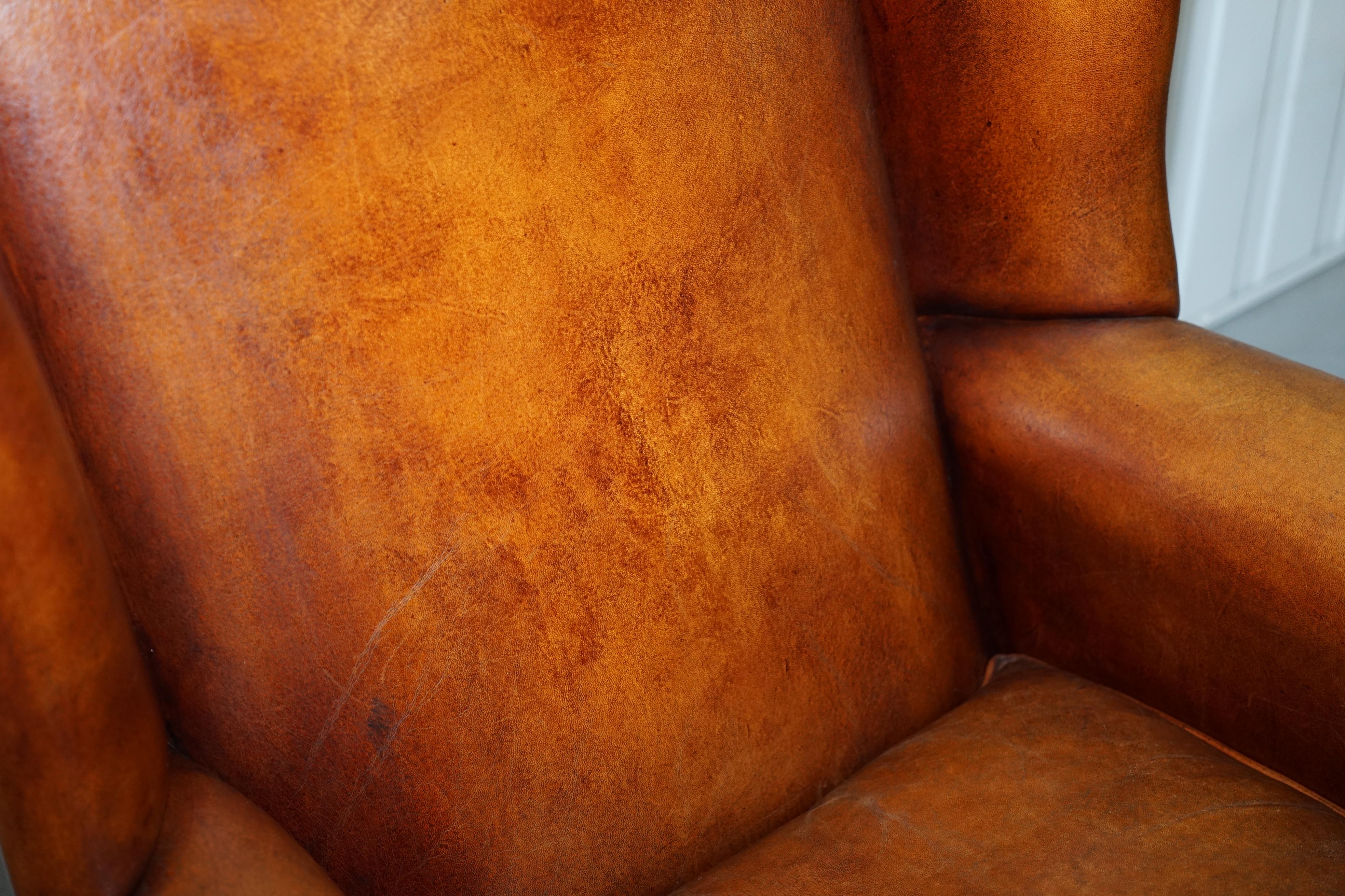 20th Century Pair of Vintage Sheepskin Leather Aged Brown Wingback Armchairs Carved Wood Legs