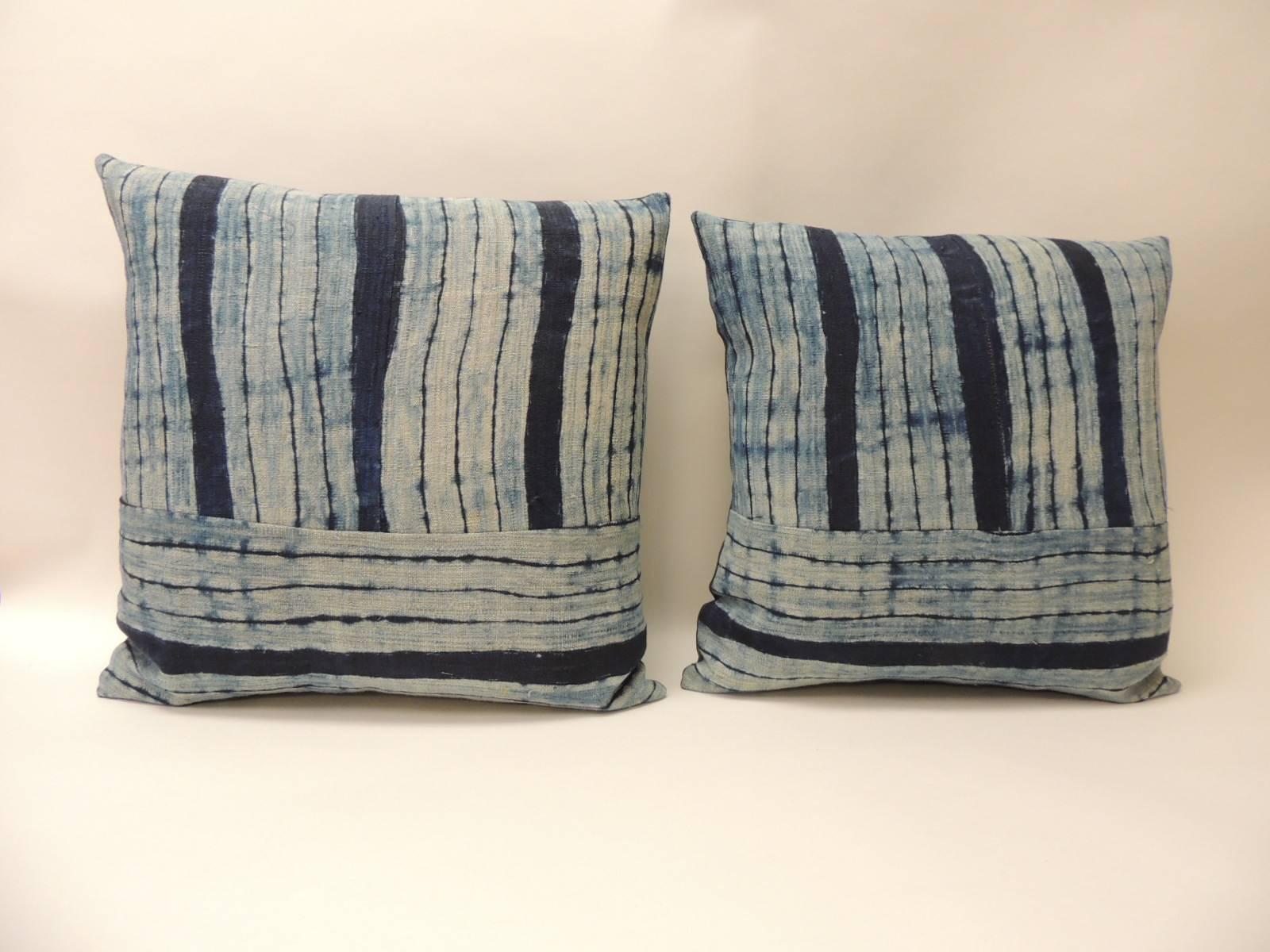 Pair of vintage Shibori stripes blue Asian decorative pillows.
Pair of square Indigo stripe homespun hemp textile with dark blue linen backings. Combination of vertical and horizontal stripes to create this unique pattern,
Decorative bolster