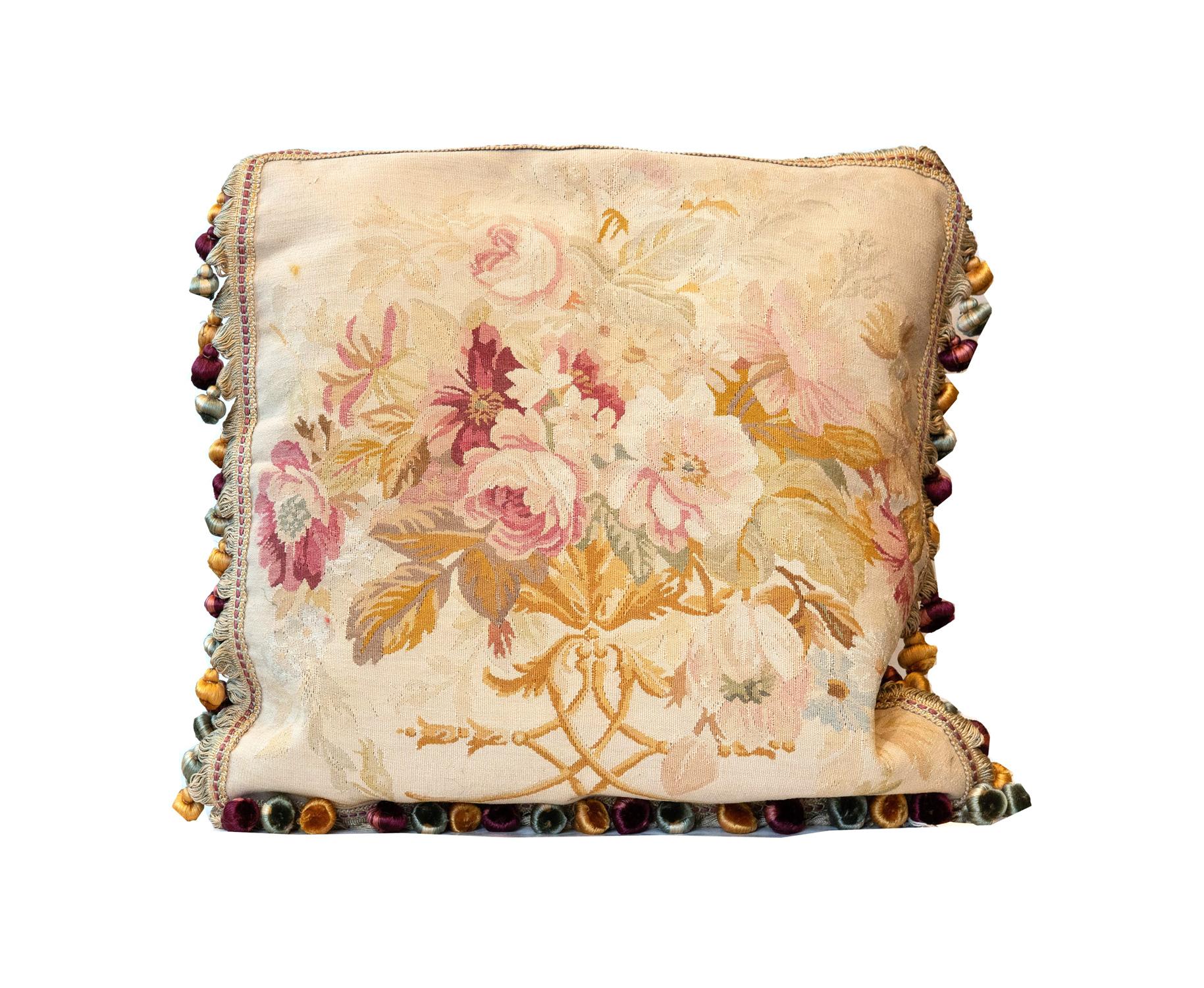 These cushions are fine examples of needlepoints from the 1990s, constructed in china with the traditional French Aubusson style and technique. These Aubusson style cushions feature a floral design in the centre woven in accents of pink, beige,