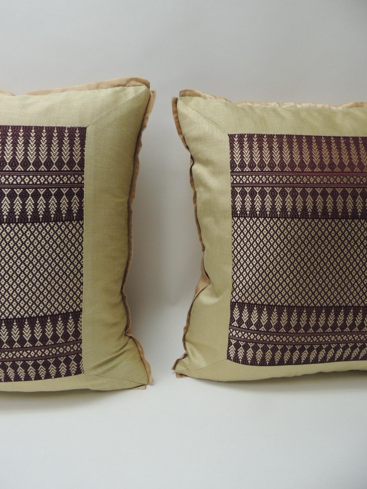 Pair of vintage silk burgundy and gold woven textile square decorative pillows
vintage gold and burgundy woven silk Asian artisanal textile decorative square pillows. The vintage silk Asian textile in the front of the pillow is framed with gold
