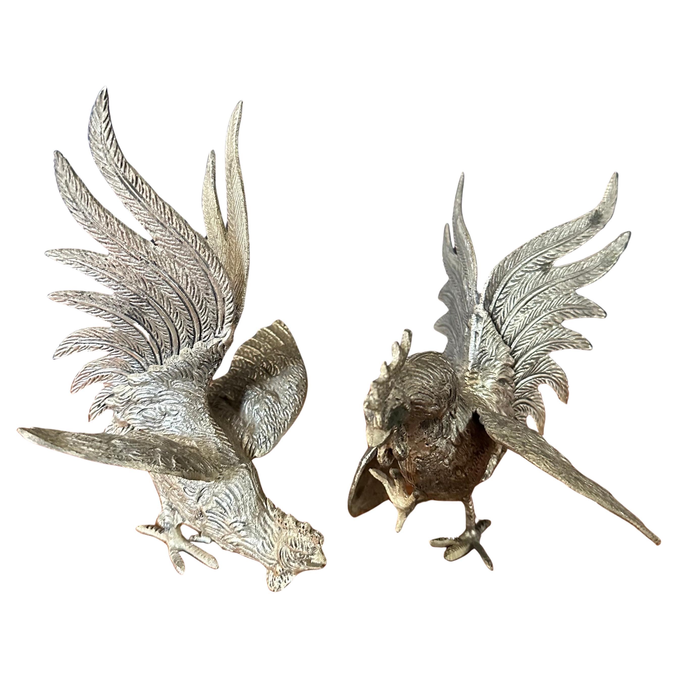 A well made pair of vintage silver plate fighting cock / rooster sculptures, circa 1970s.  The set is in very good vintage condition with a nice patina and measures 10