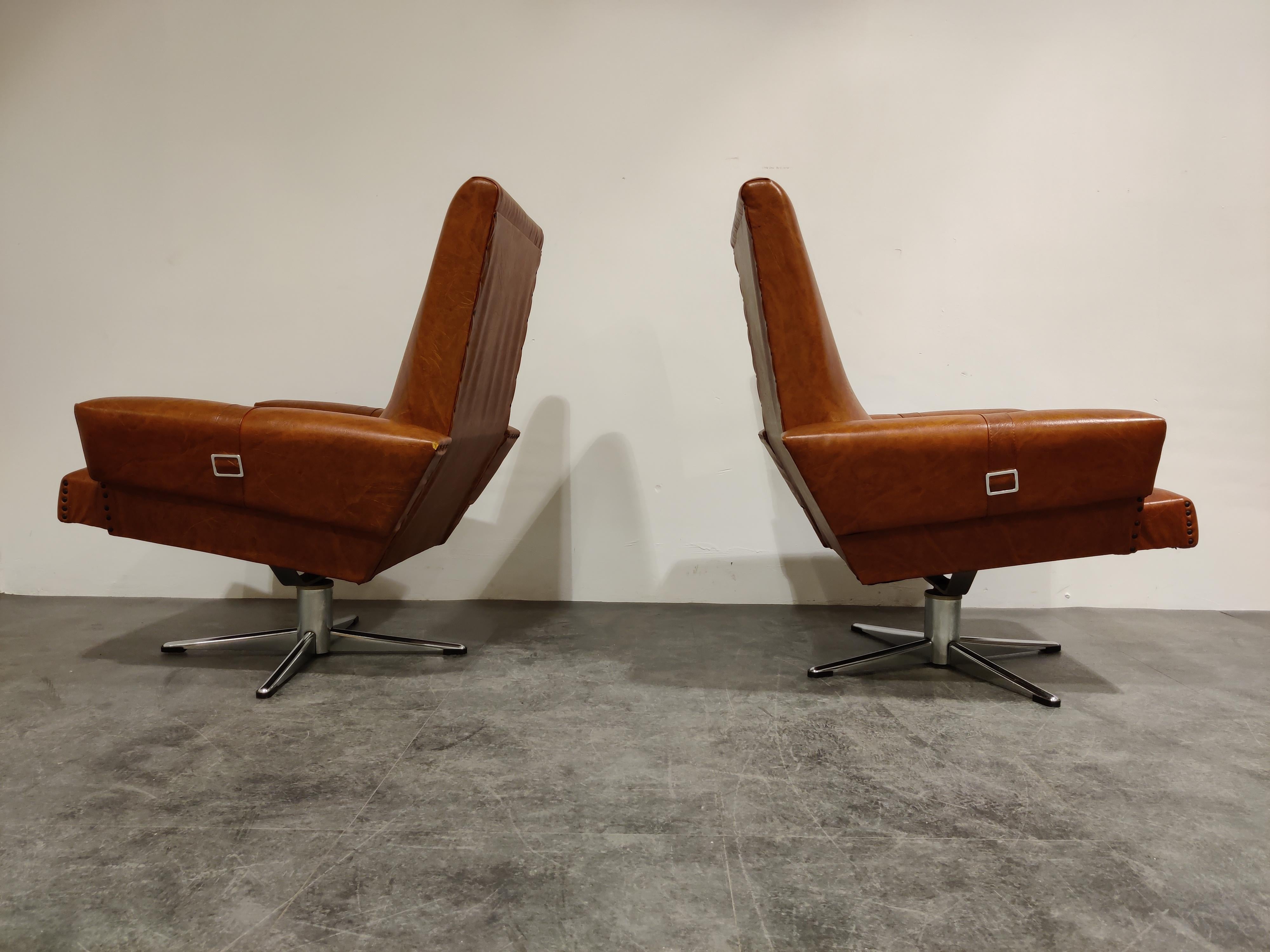 Pair of Belgian brown skai swivel chairs on a chrome base.

The chairs have a beautiful color and have their original upholster.

They are very comfortable.

Condition:
Corners at the back of the armrests have some damages
One chair has a