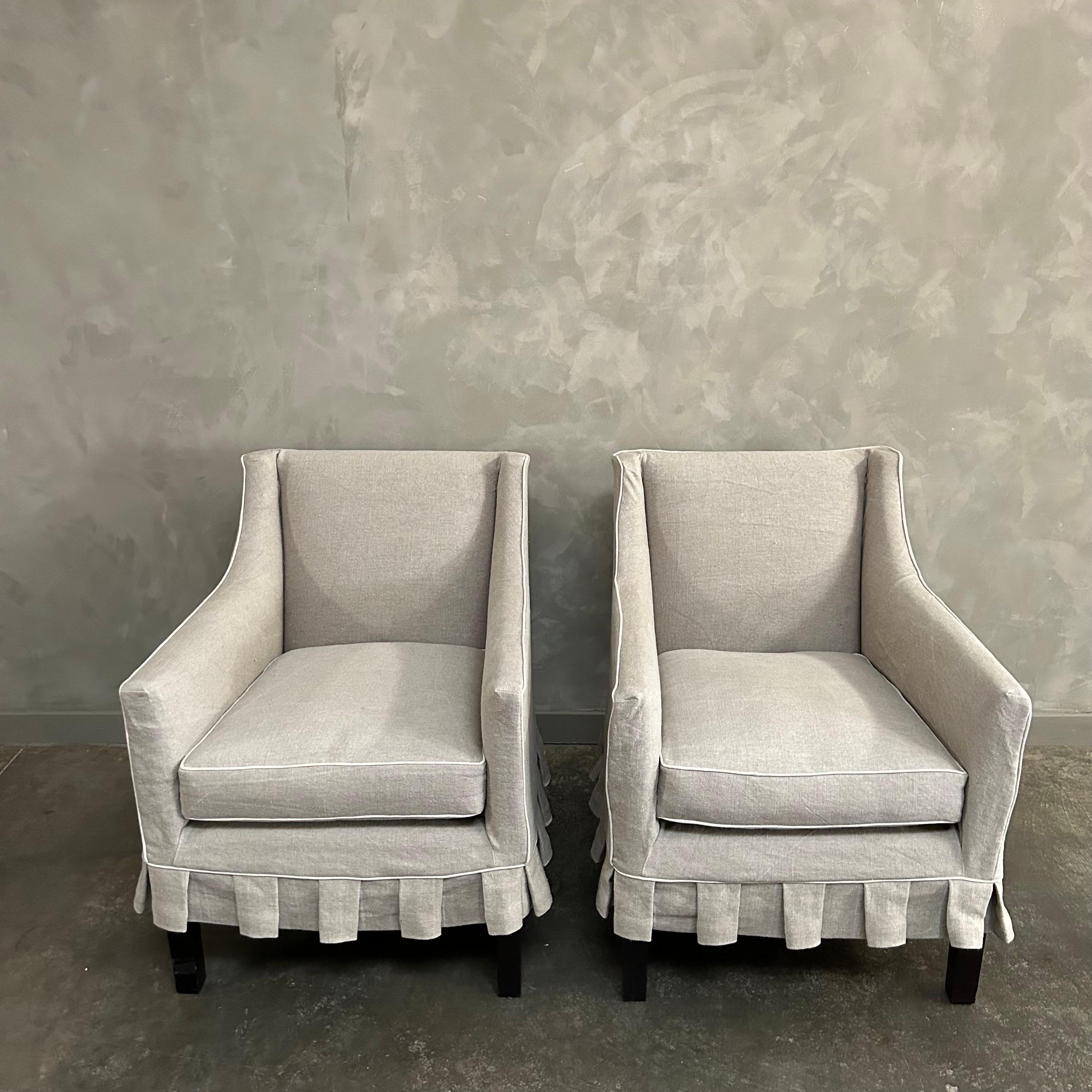 Pair of vintage chairs c1960s New York custom made.
A gold cotton upholstery is slip covered in a beautiful heavy weight nubby natural Irish linen, with pleated ruffle skirt and contrasting welt.
The seats are a high quality down feather wrapped