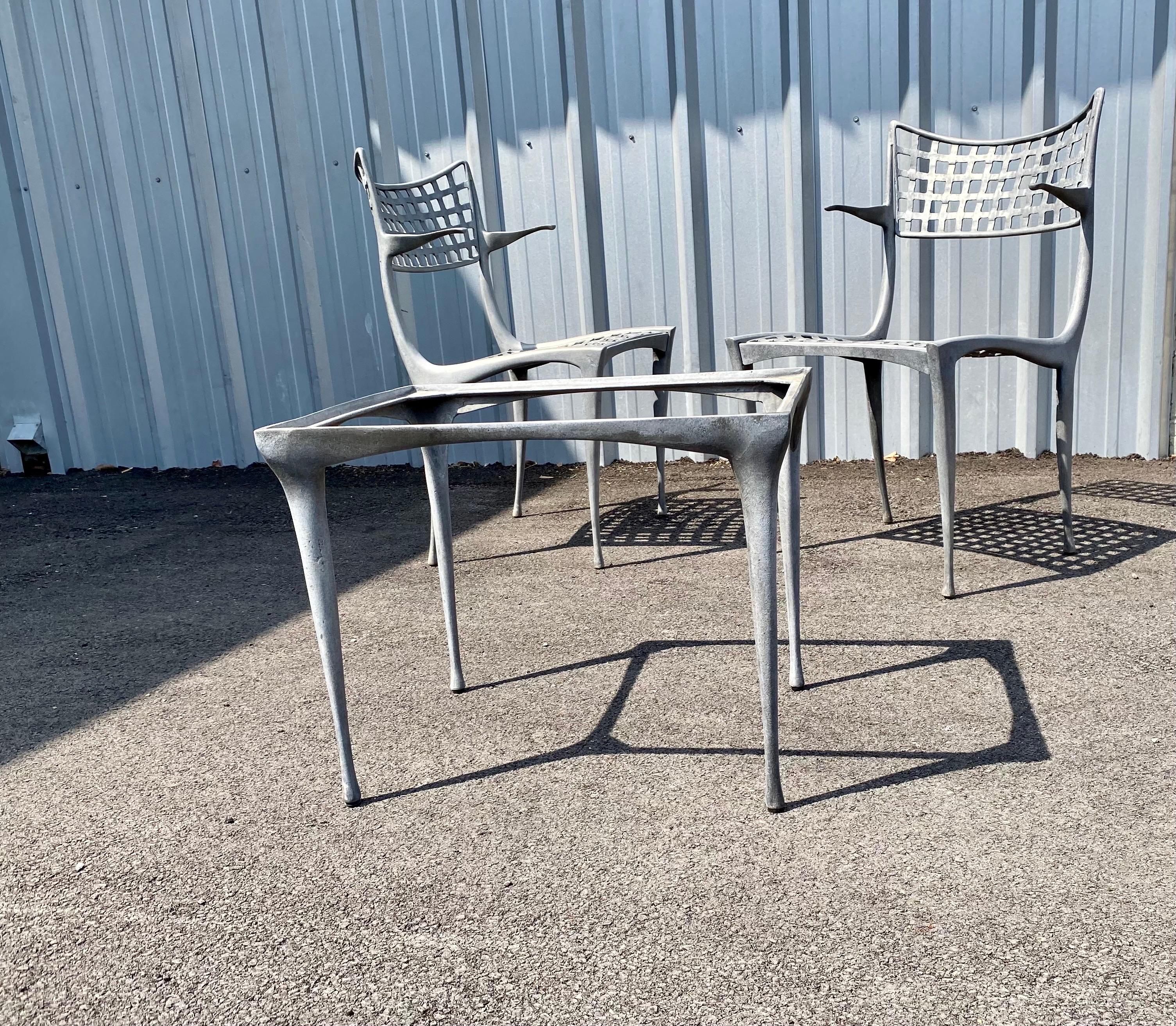 Pair of Sol Y Luna patio chairs with arms and a side table by Dan Johnson for Brown Jordan. Patio chairs and patio table is made of cast aluminum and powdered coated. **The patio side table is having new glass made. This set is perfect for a small