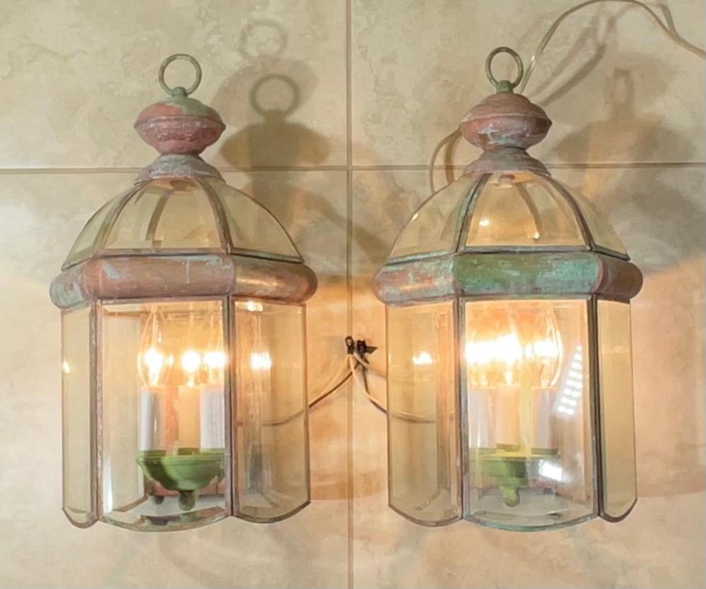 Elegant pair of wall lantern hand crafted from brass with three 60/watt lights each. 
 Suitable for wet locations, electrified and ready to use.
Beautiful beveled glass dome. Nice patina .
decorative pair of lantern indoor or outdoor.