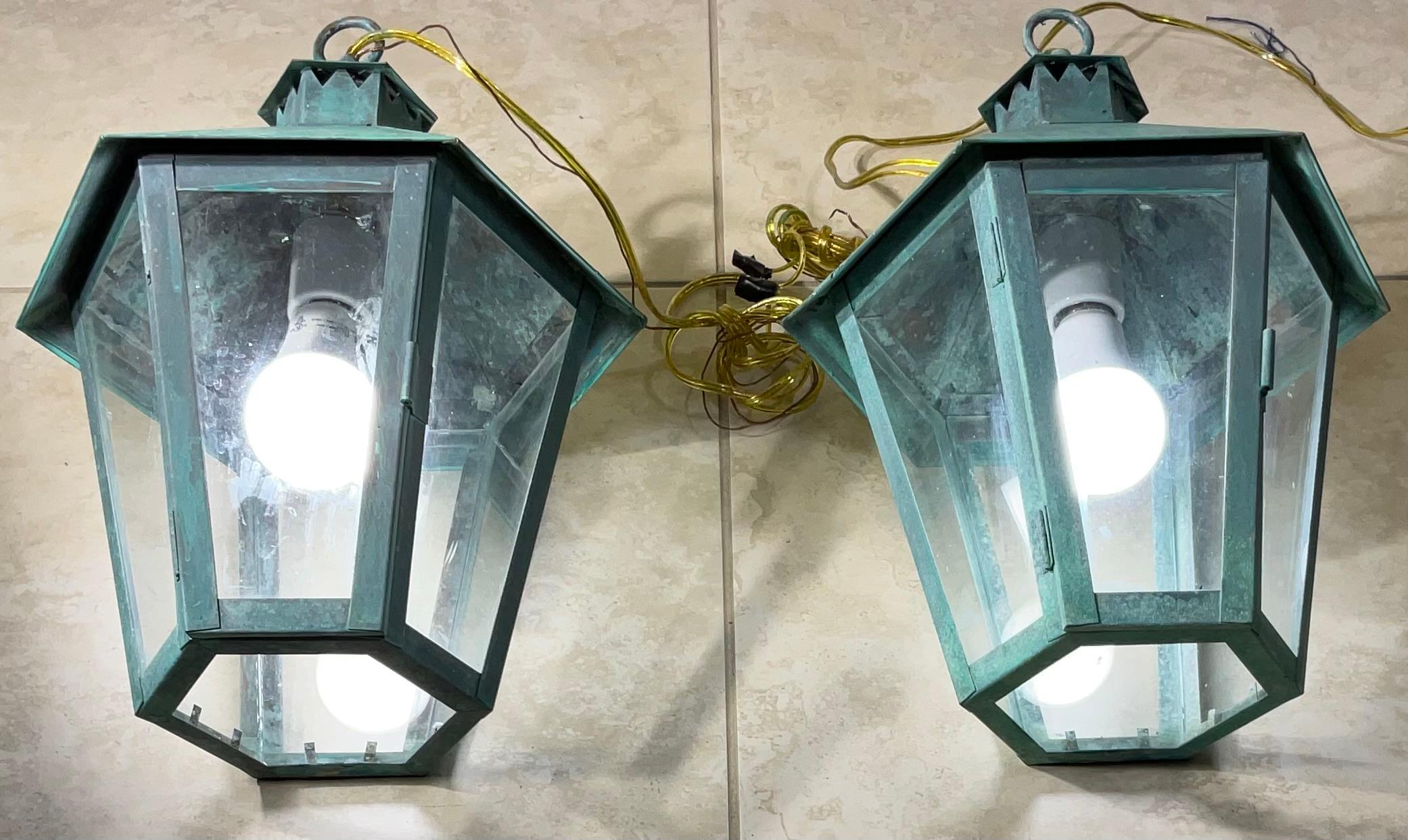 
pair of vintage solid brass hanging lanterns, perfect for adding a touch of timeless elegance to any space. These beautiful pendant lights, with their classic hexagonal design, are a rare find and a true testament to quality craftsmanship.
Their