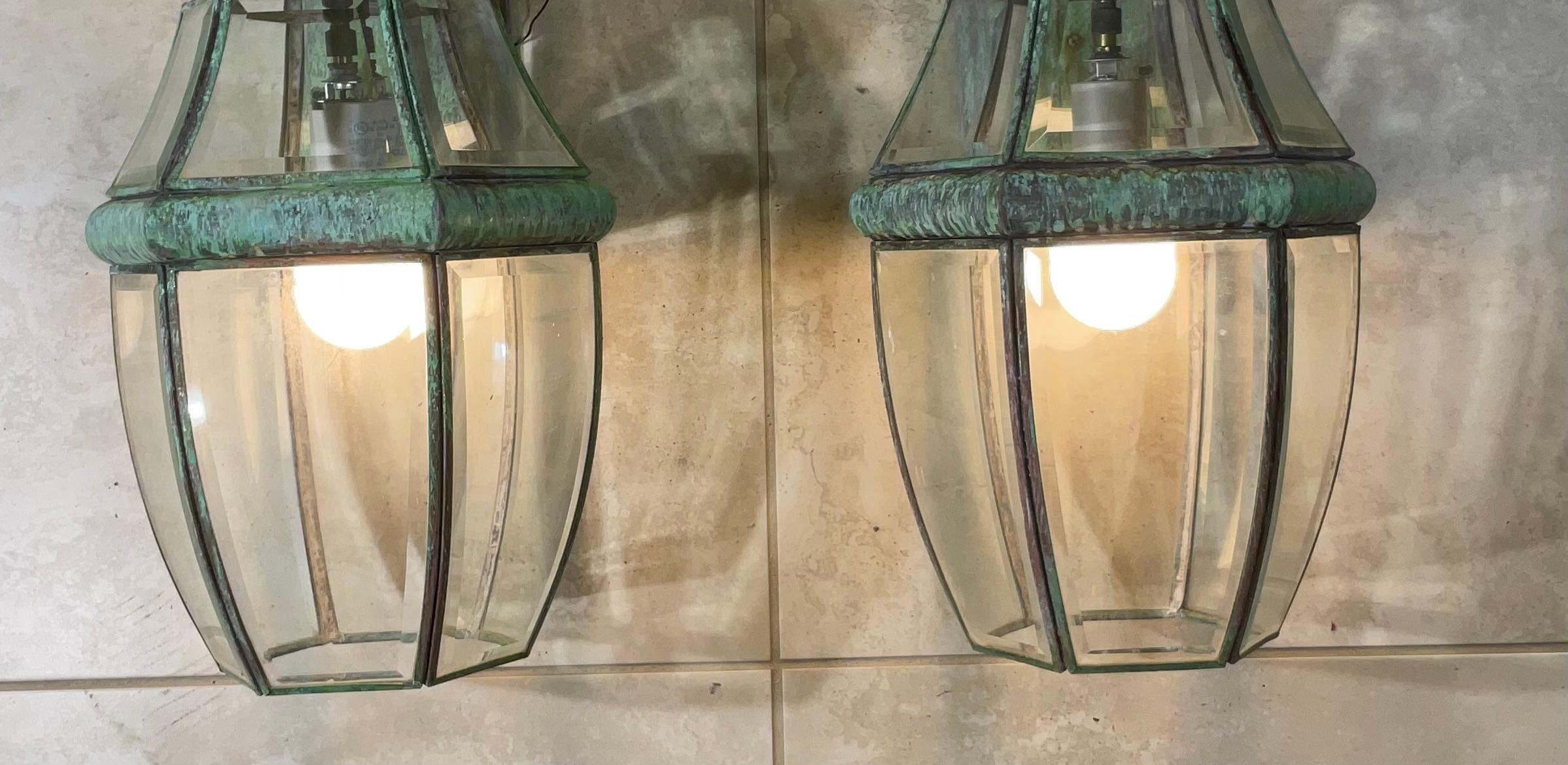 Elegant pair of wall lantern hand crafted from brass with one 60/watt lights each. 
 Suitable for wet locations, electrified and ready to use.
Beautiful thick beveled glass.
Decorative pair of lantern indoor or outdoor.